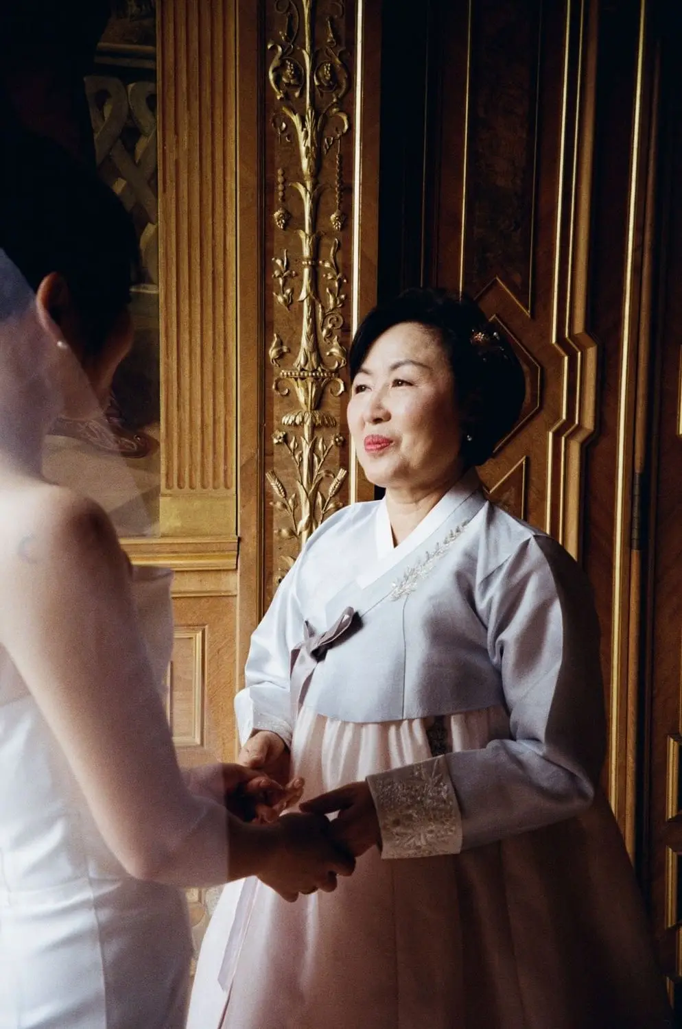 Bride in a white hanbok during the Korean ceremony, on 35mm film