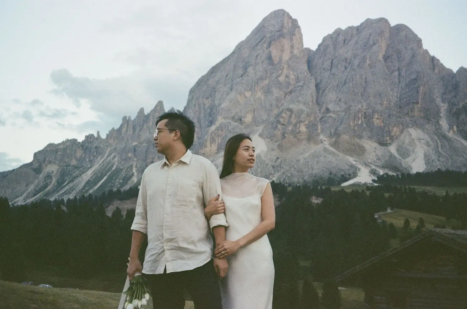 Newly engaged couple arm in arm below the Sass de Putia, on 35mm film