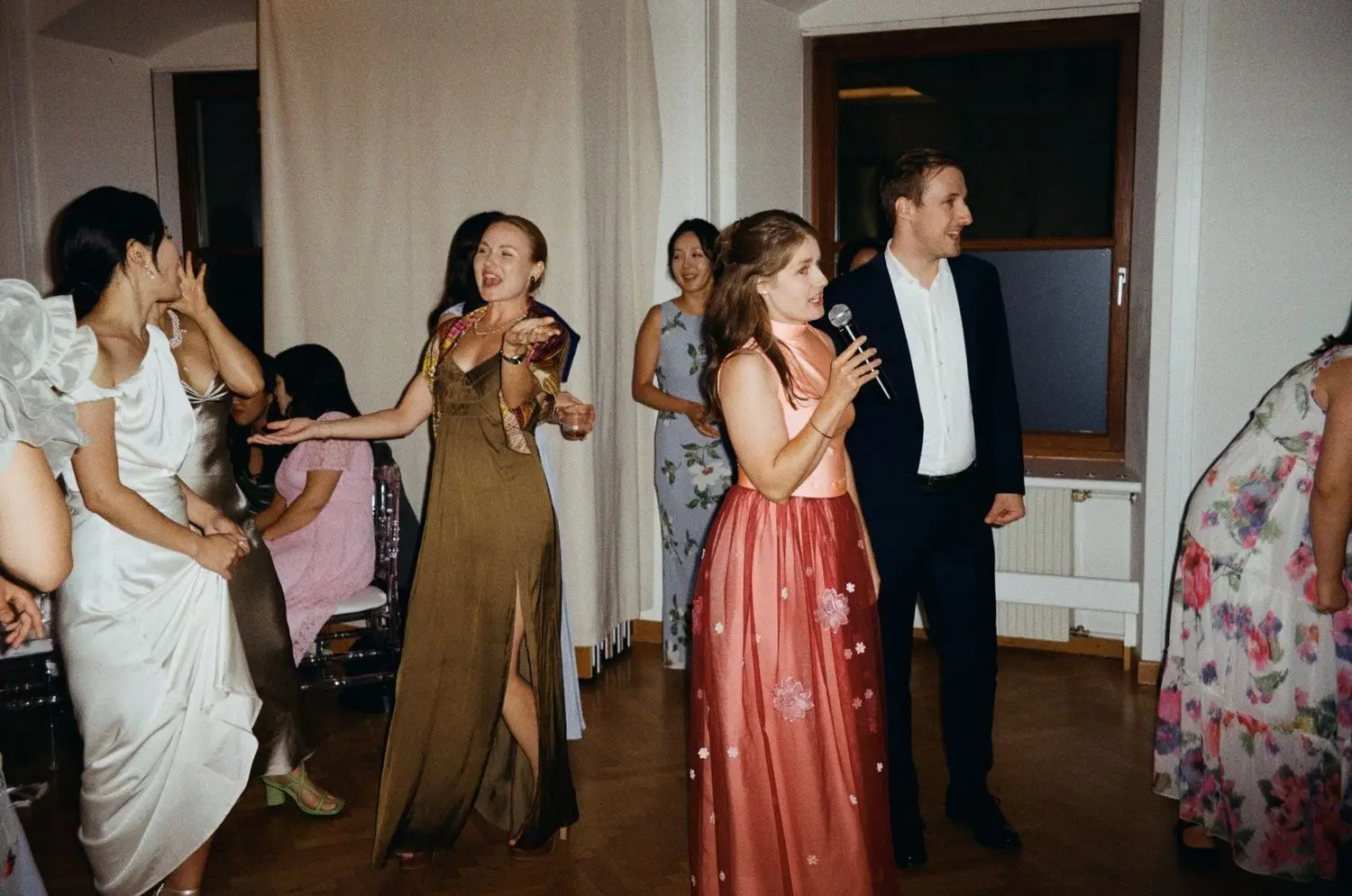 Guests singing karaoke at the wedding party, on 35mm film