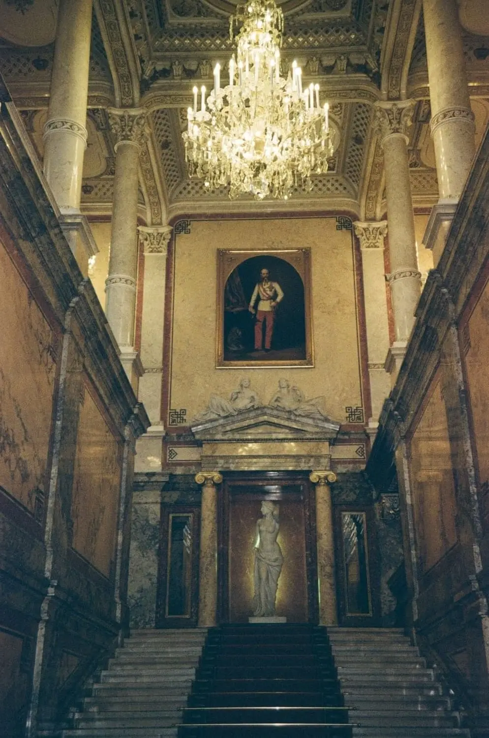 Grand palace staircase with a chandelier, on 35mm film