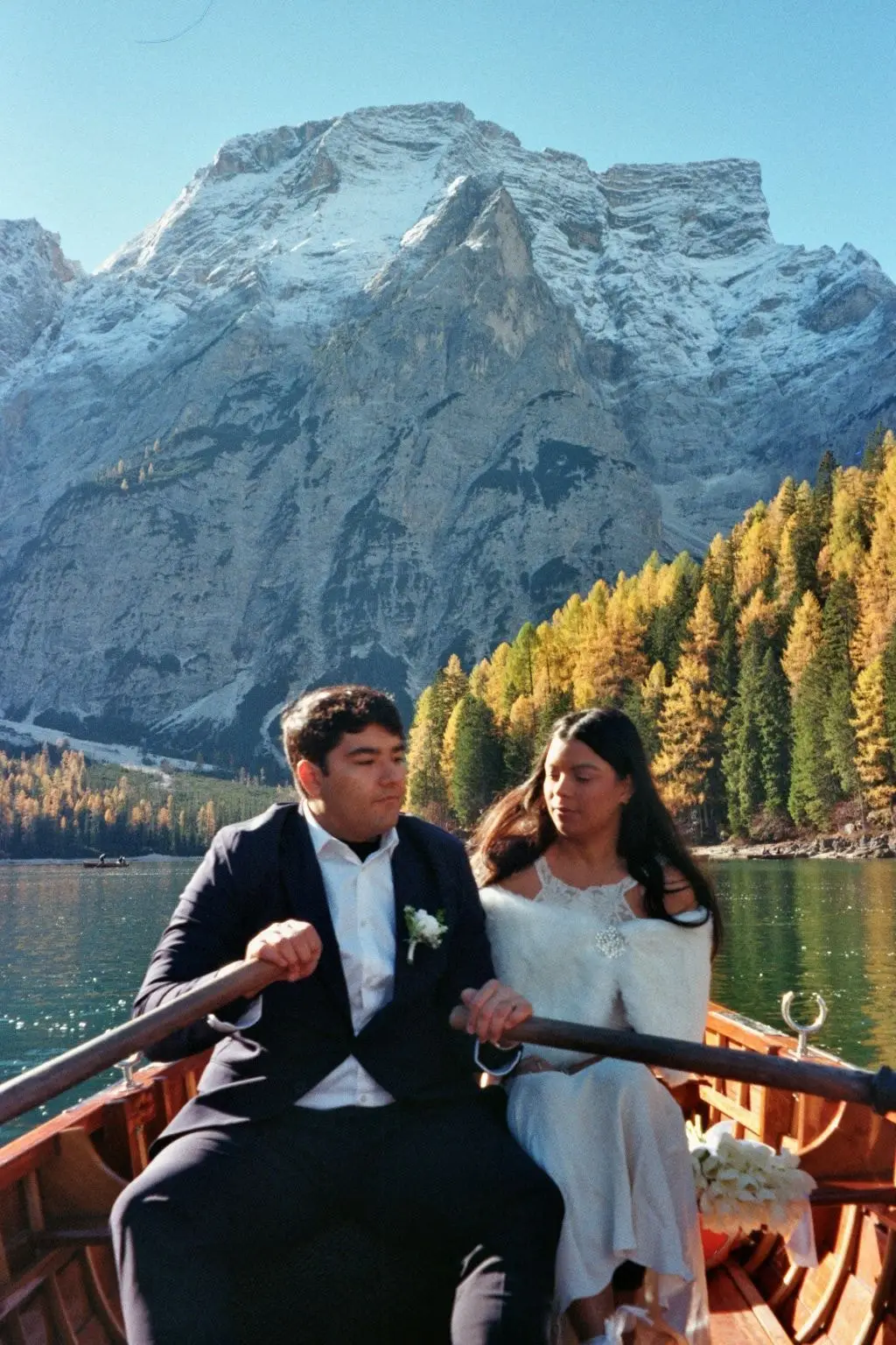 Couple rowing on Lago di Braies in autumn, on 35mm film