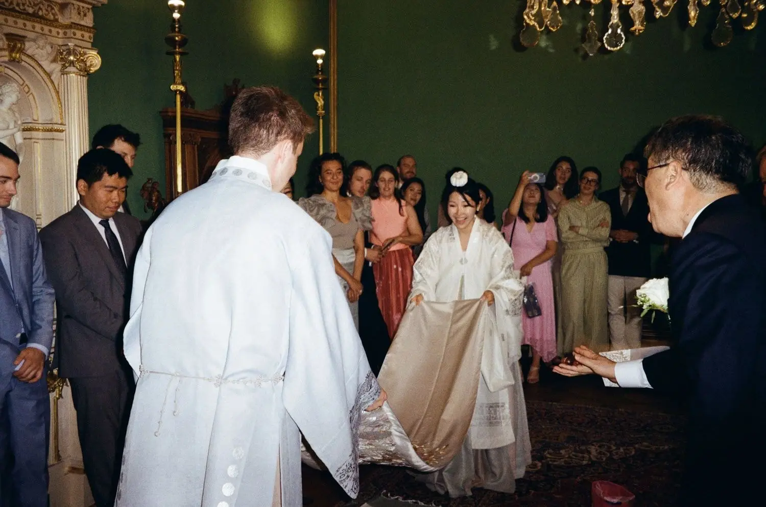 Bride in hanbok during the Korean ceremony with guests watching, on 35mm film