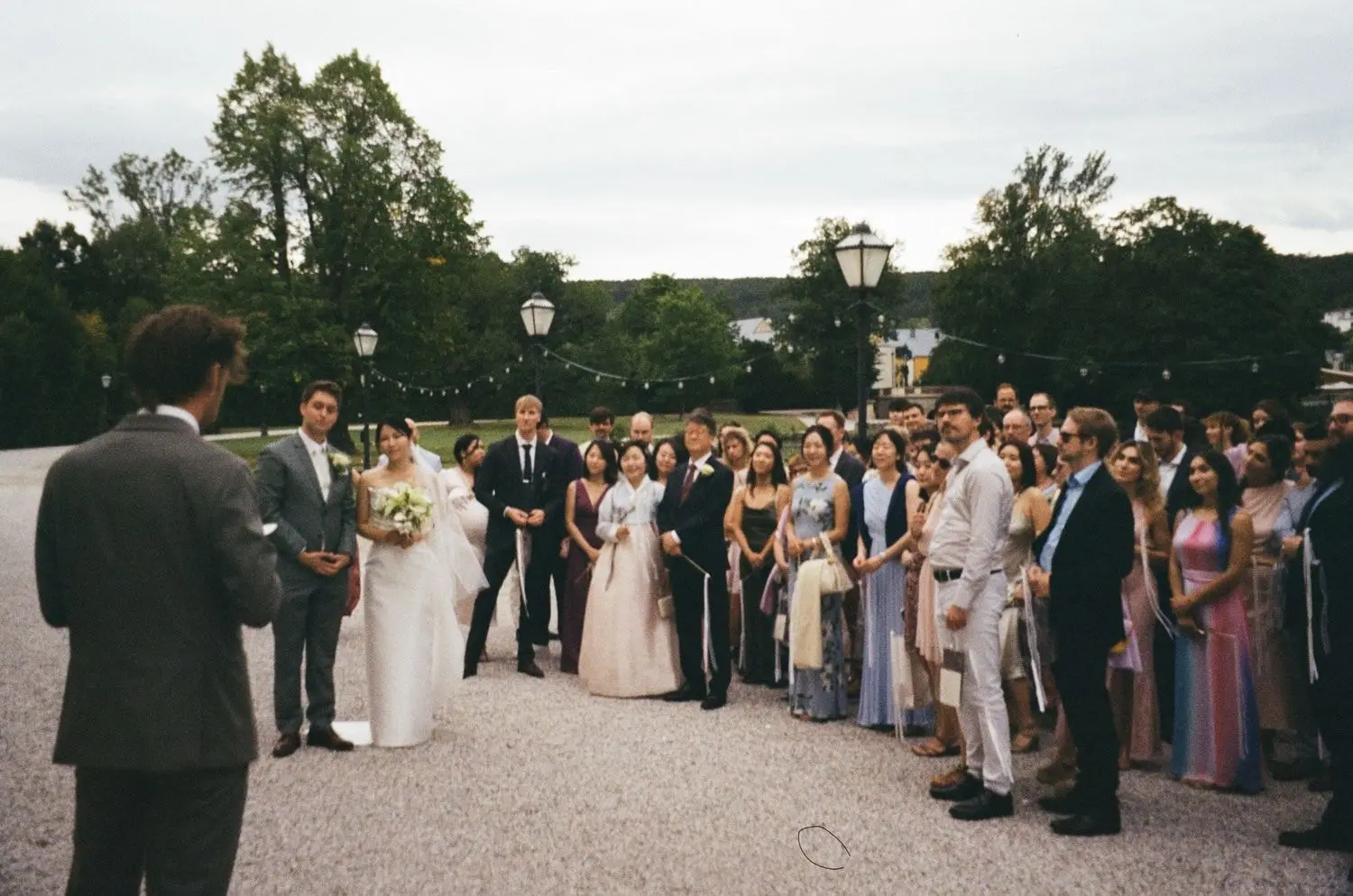 Wedding guests gathered in the castle courtyard, on 35mm film