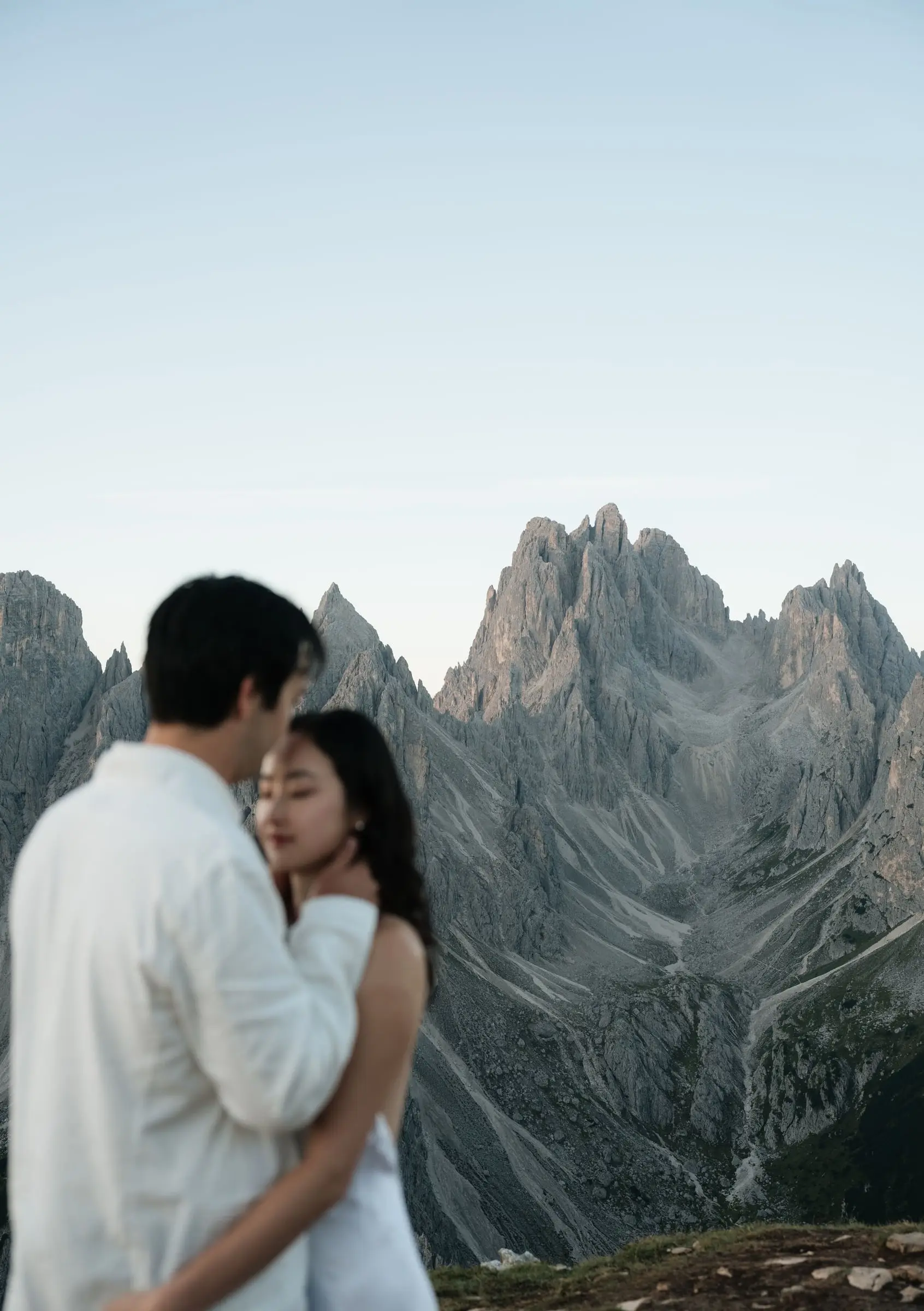 Couple embracing in front of the needle-sharp Cadini di Misurina peaks