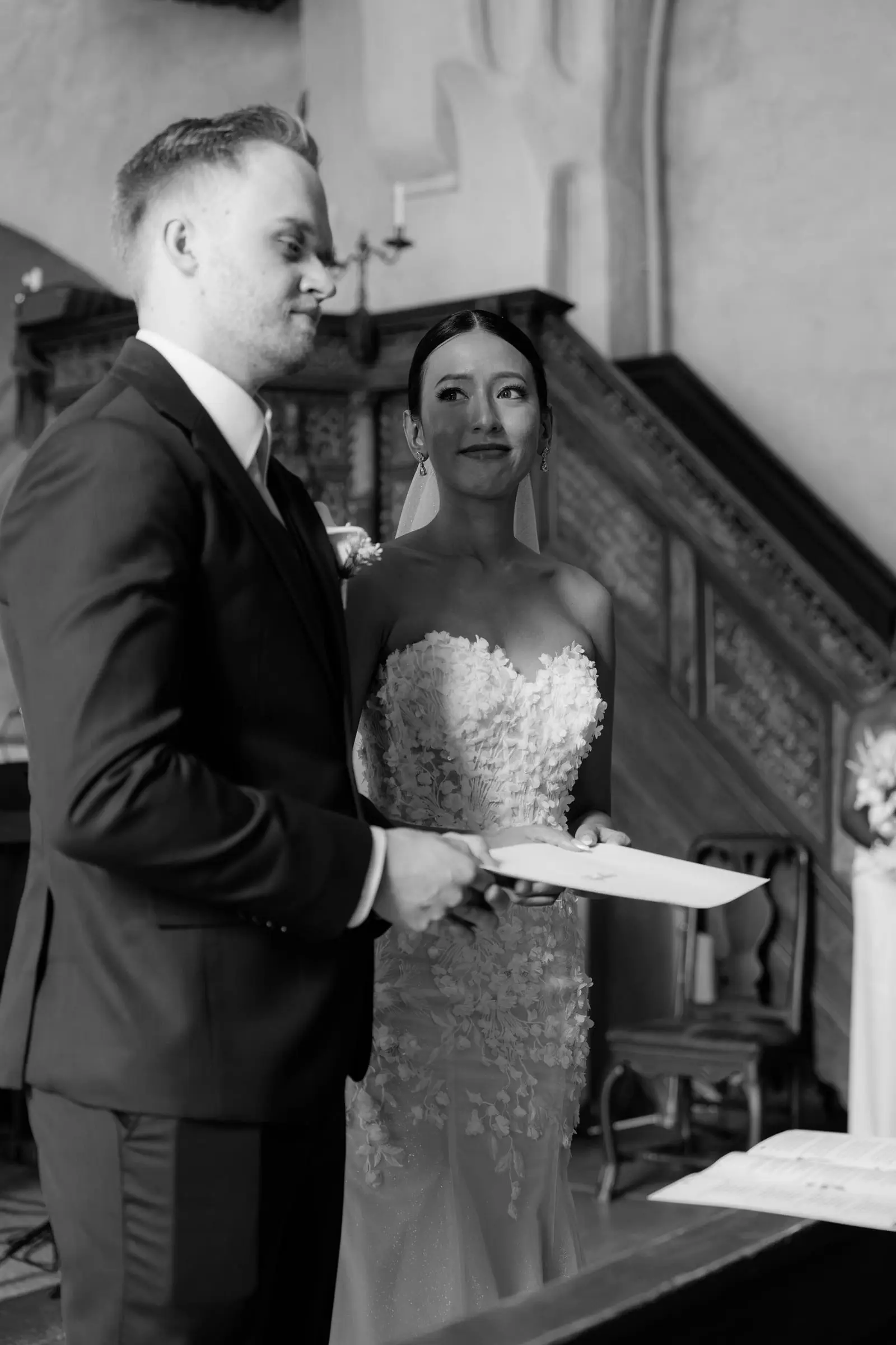 Black and white photo of the couple reading their vows