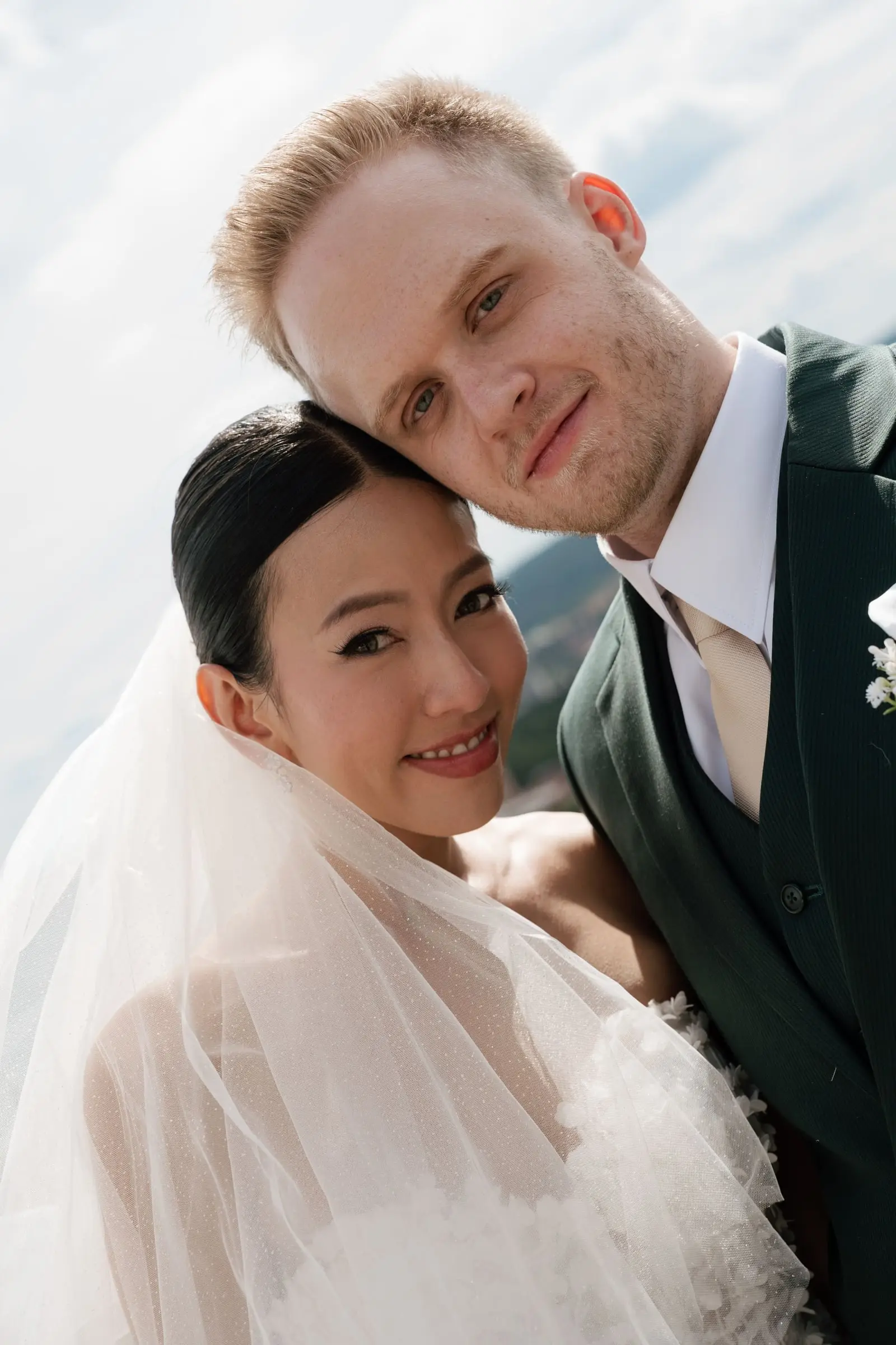 Portrait of the bride and groom cheek to cheek