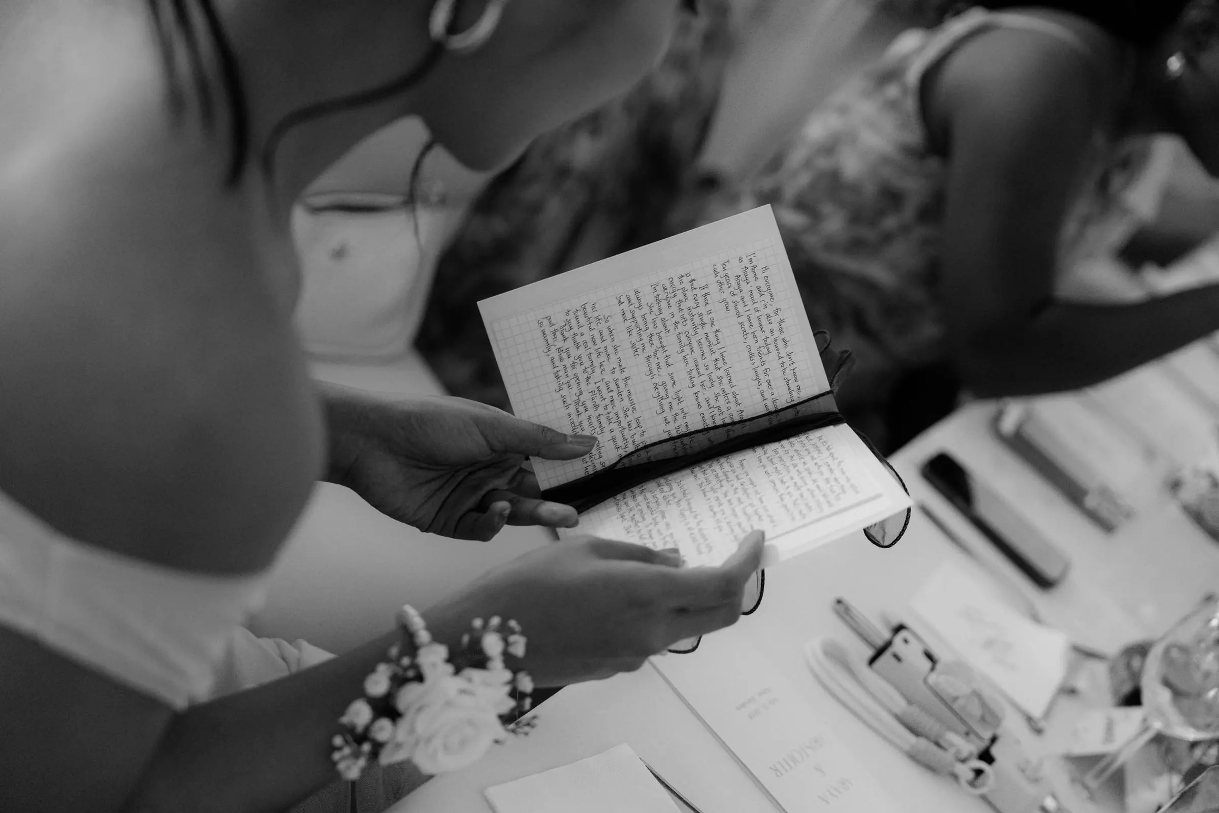 Black and white detail of a guest reading a hymn book