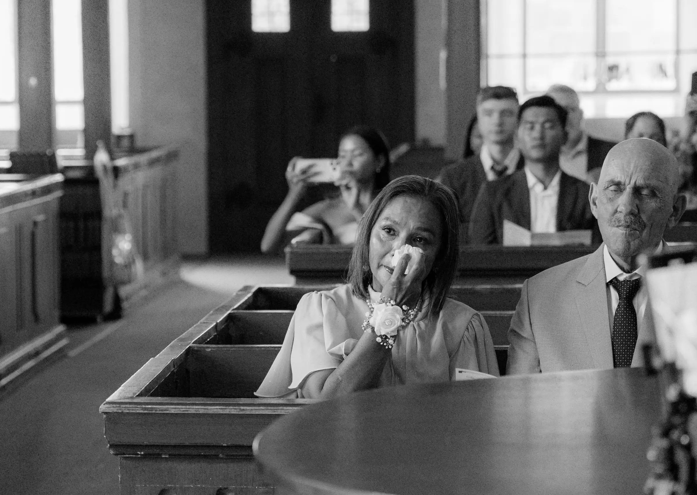 Black and white photo of a guest moved to tears during the ceremony
