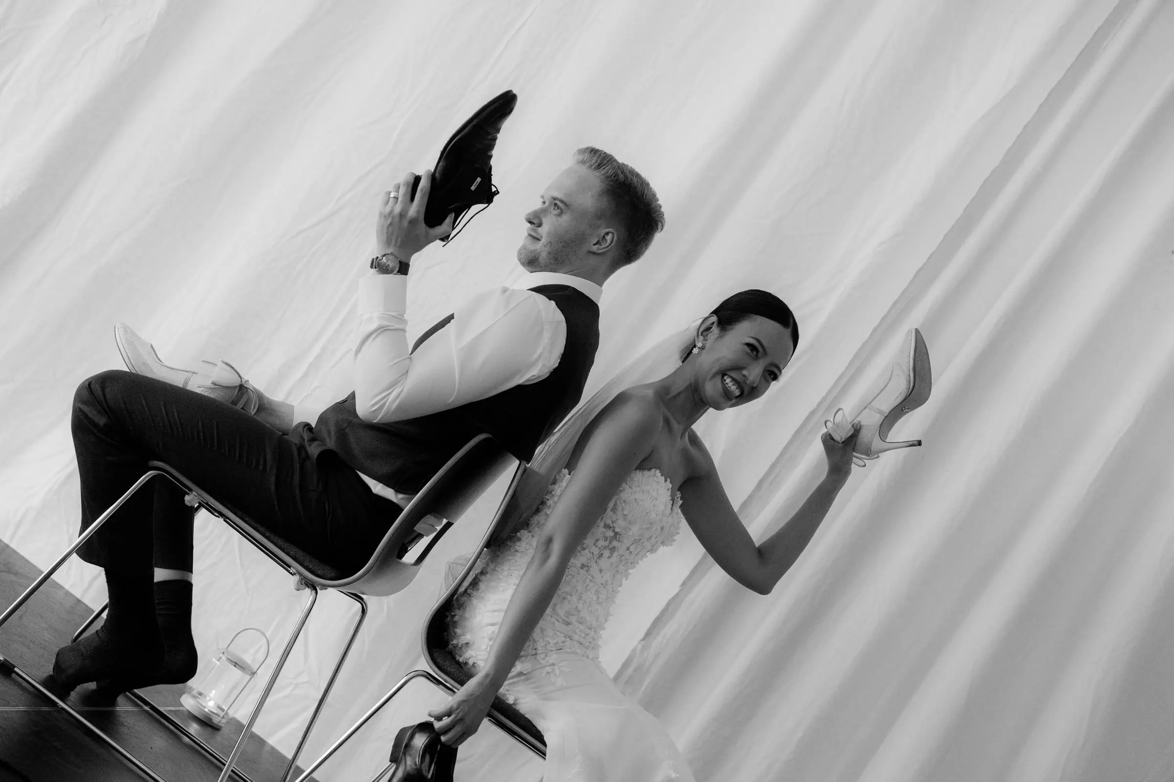 Black and white photo of the couple playing the shoe game