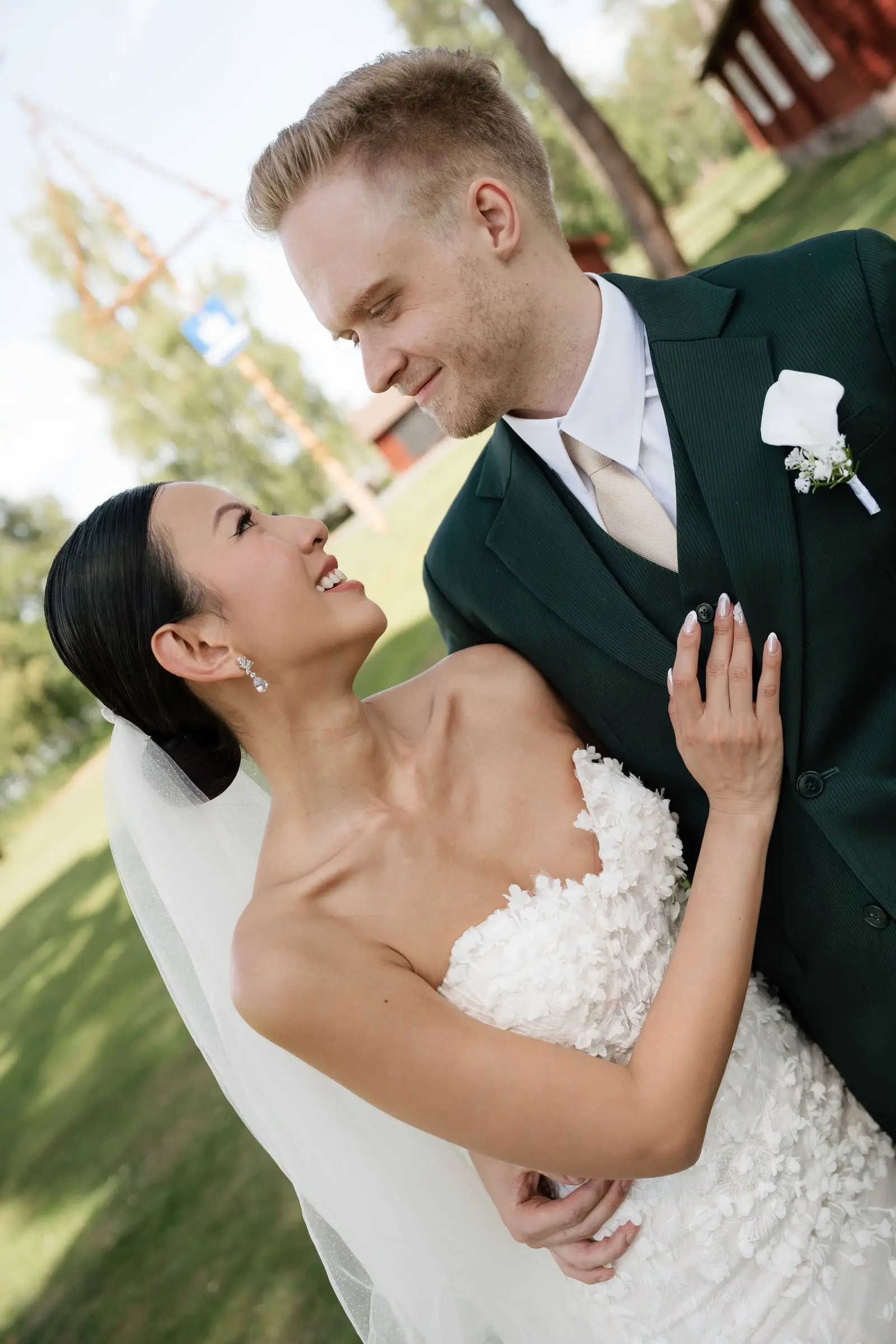 Bride and groom laughing together on the lawn
