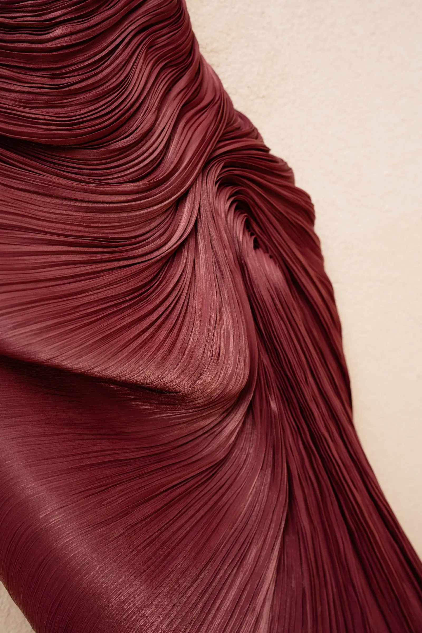 Detail of a pleated burgundy gown