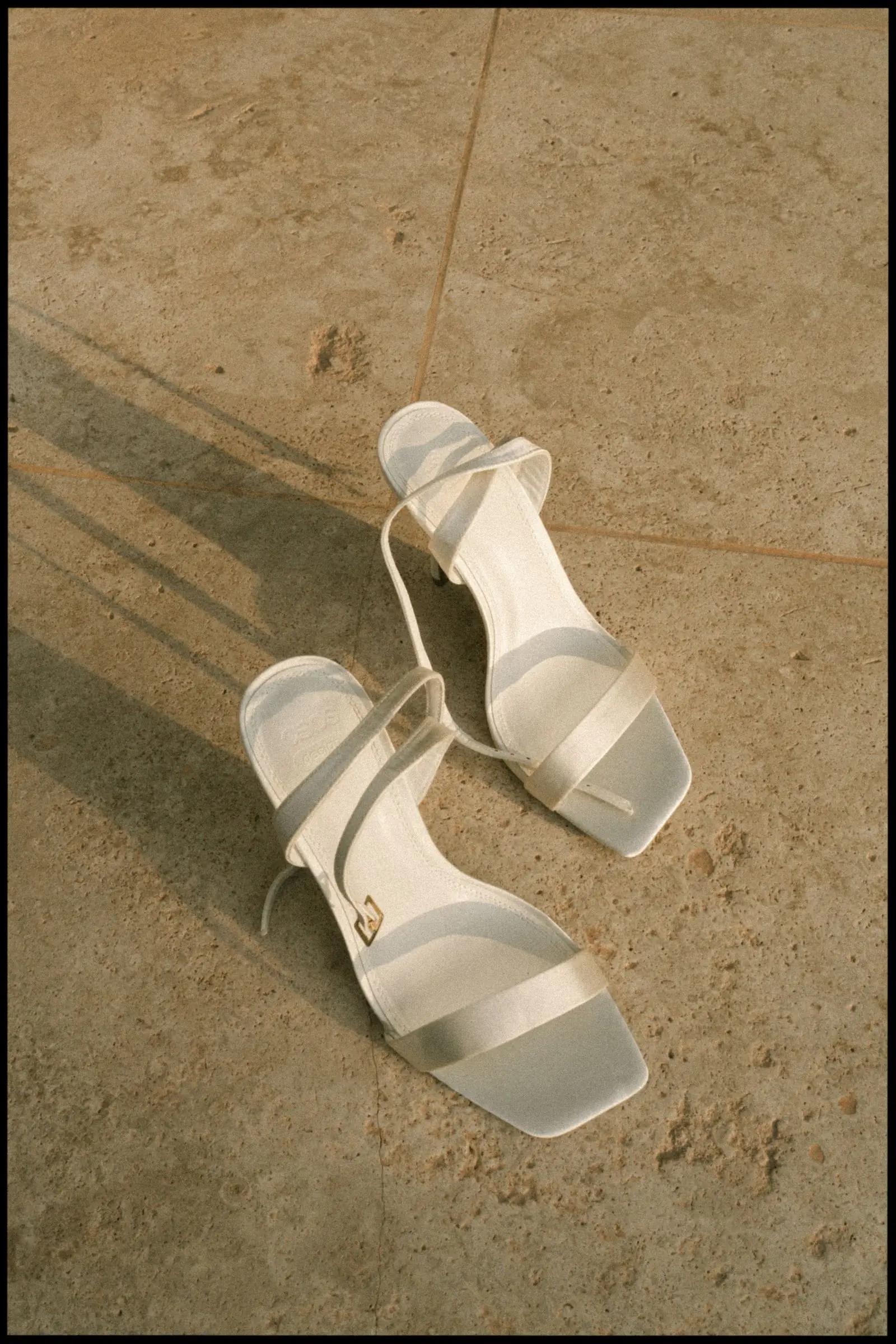 Bridal sandals on a stone floor, on film