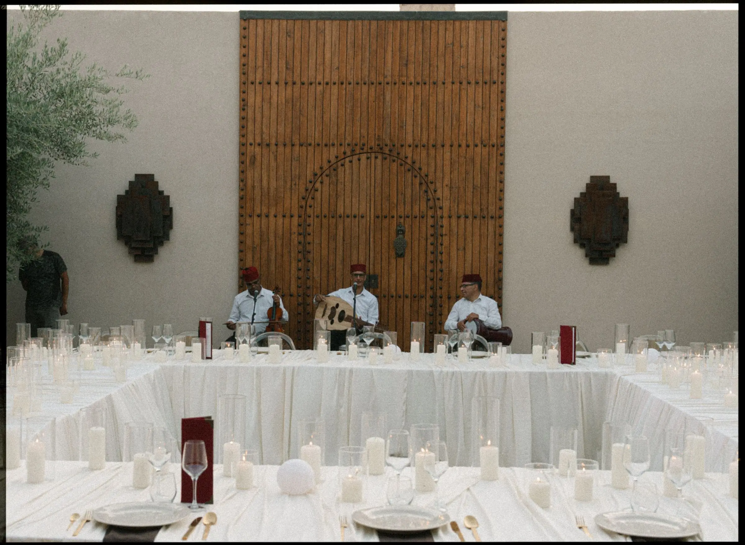 Musicians playing at the courtyard dinner table, on film