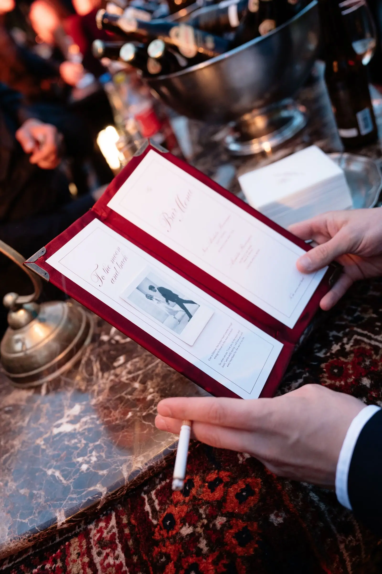 Guest reading the welcome dinner menu with a cigarette in hand