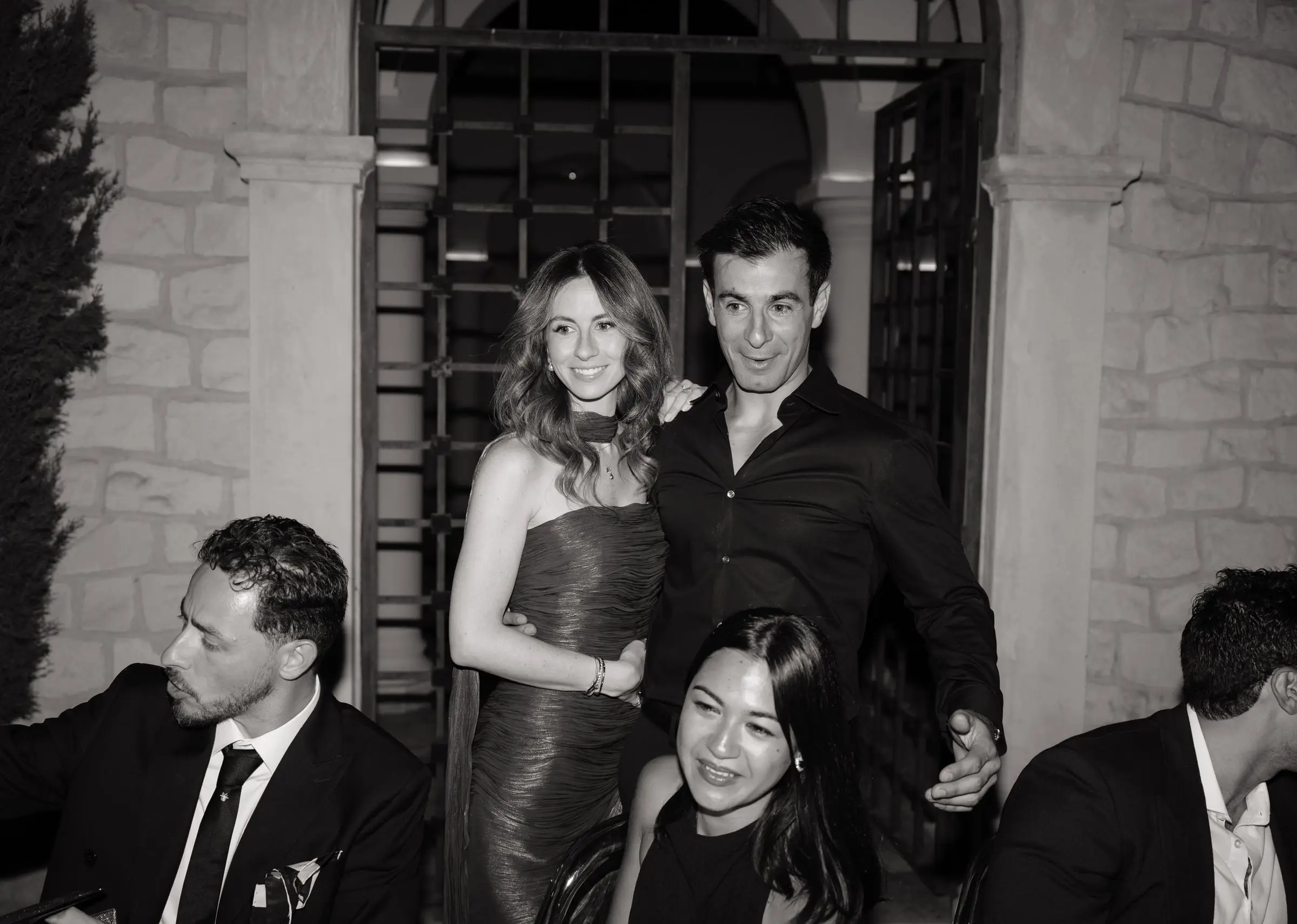 Black and white photo of guests posing at the dinner