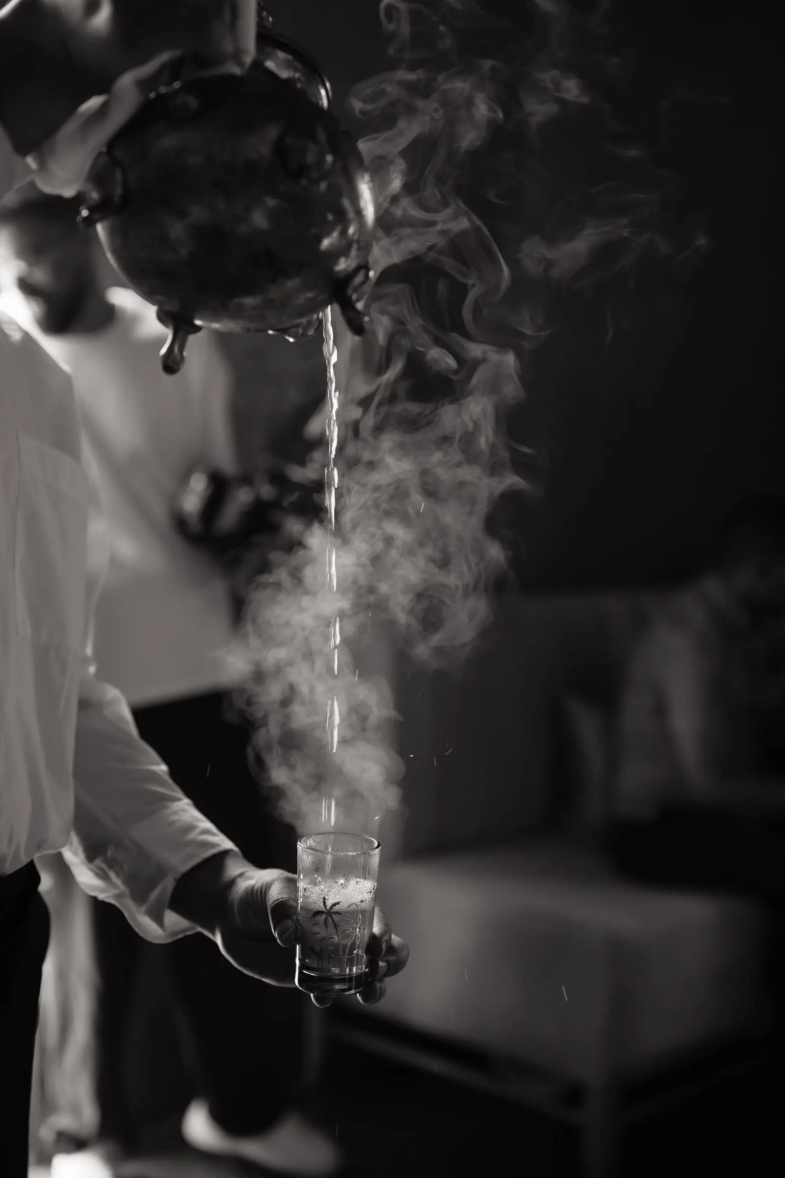 Black and white photo of mint tea being poured in the traditional way