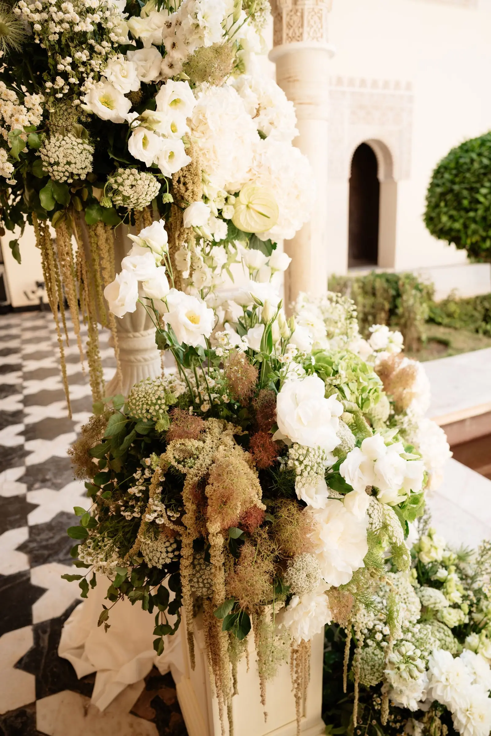 White floral arrangements at the ceremony entrance