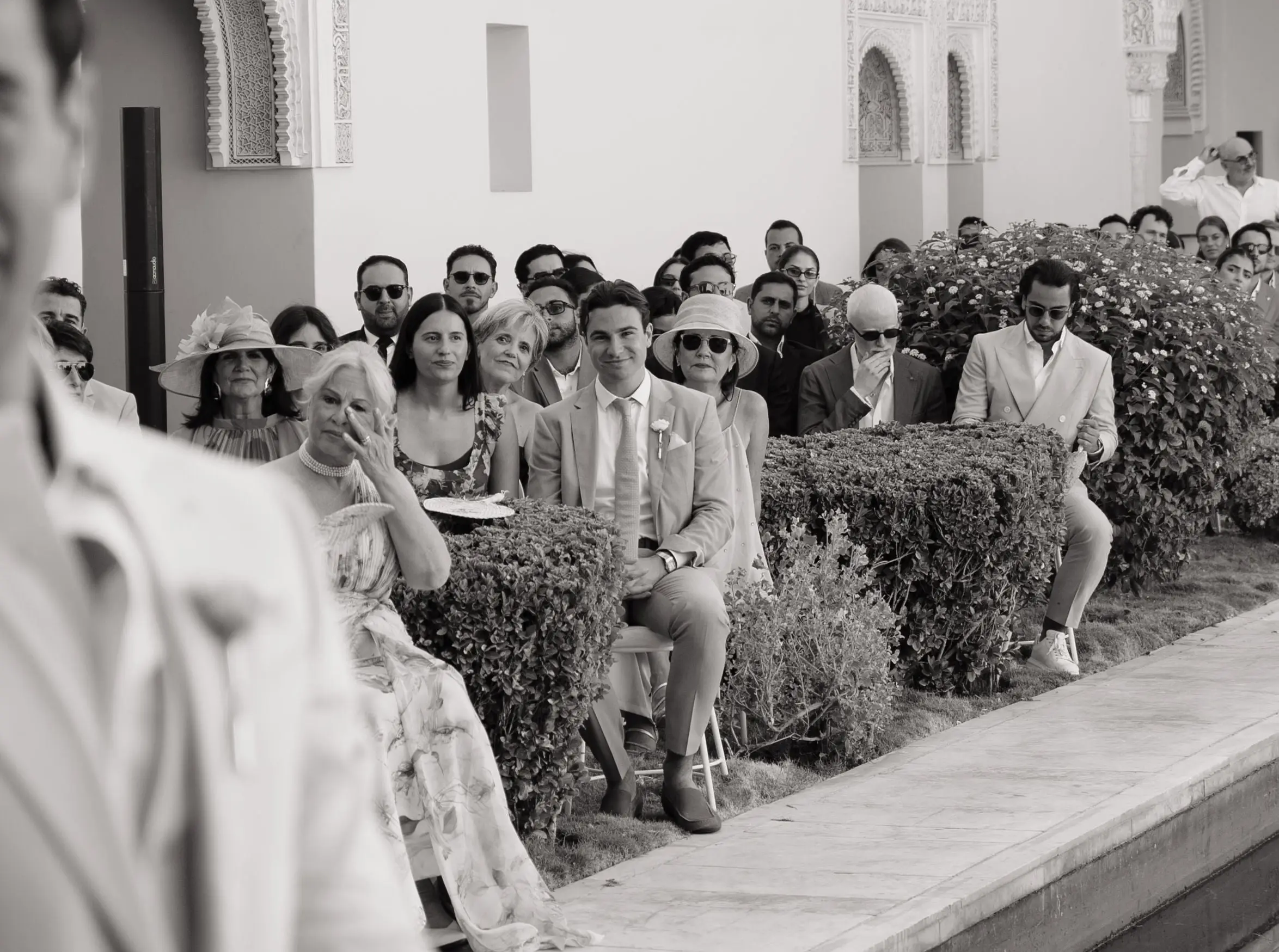 Black and white photo of guests moved during the ceremony