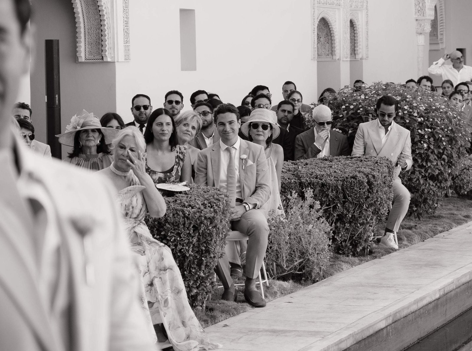 Black and white photo of guests moved during the ceremony