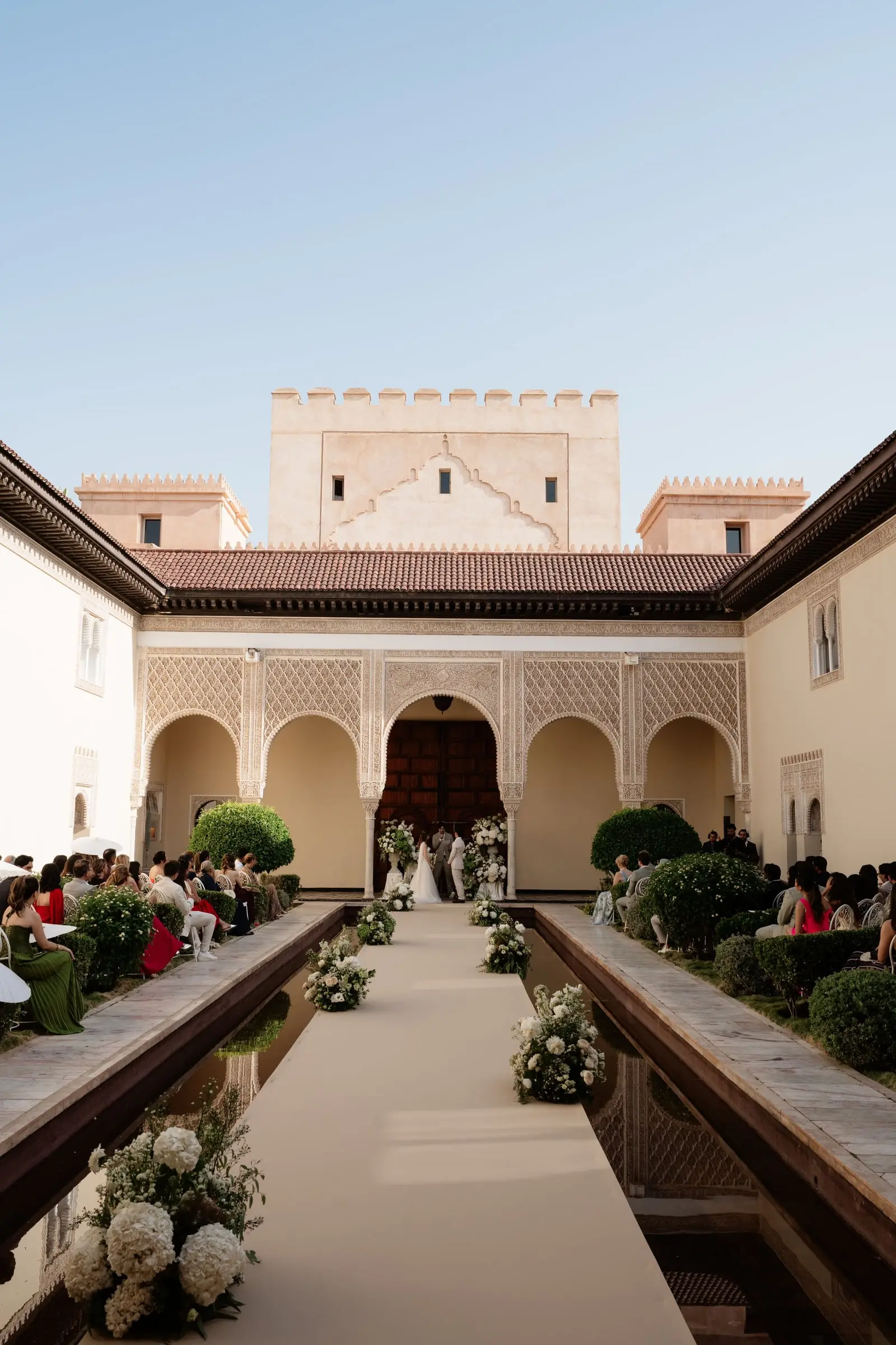 Ceremony in the Moorish courtyard of Ksar Char Bagh under a blue sky