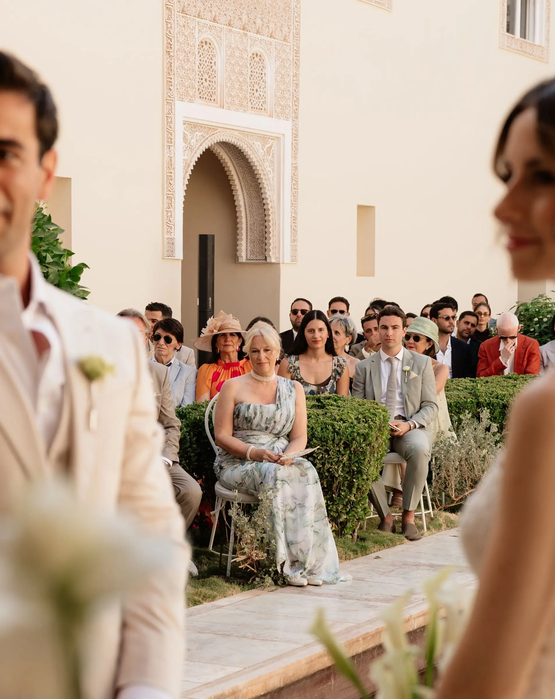 Guests watching the couple during the outdoor ceremony