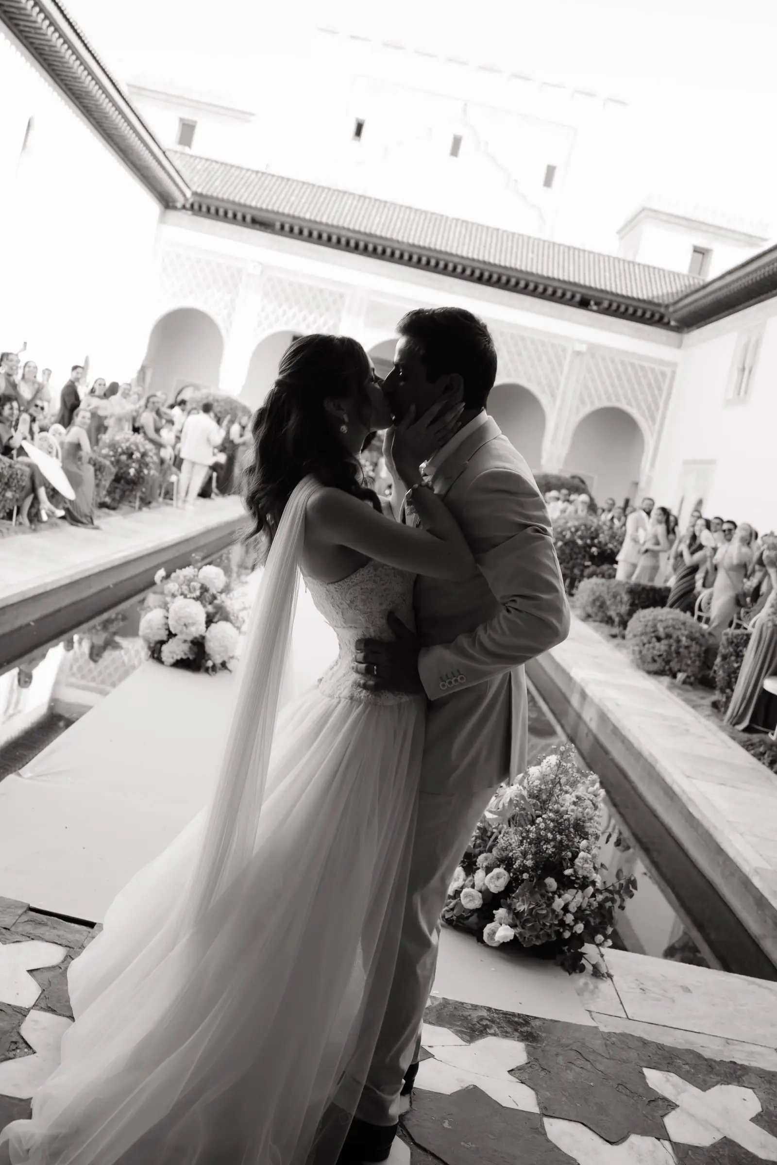Black and white photo of the first kiss in the courtyard