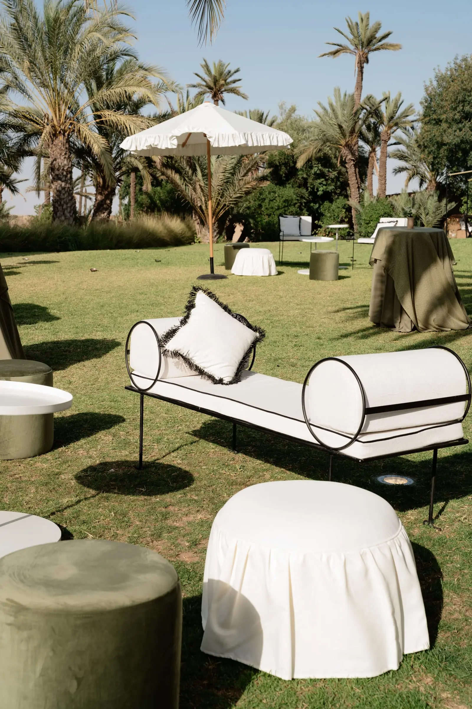 Garden lounge with daybeds and palm trees