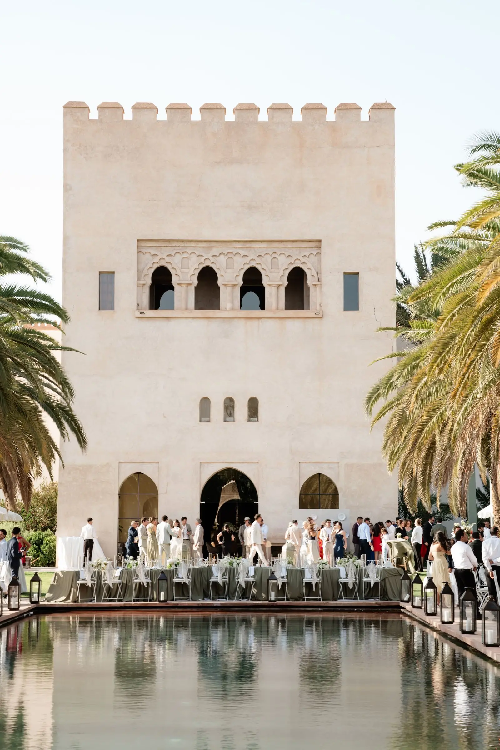 Guests gathered below the crenellated tower of Ksar Char Bagh