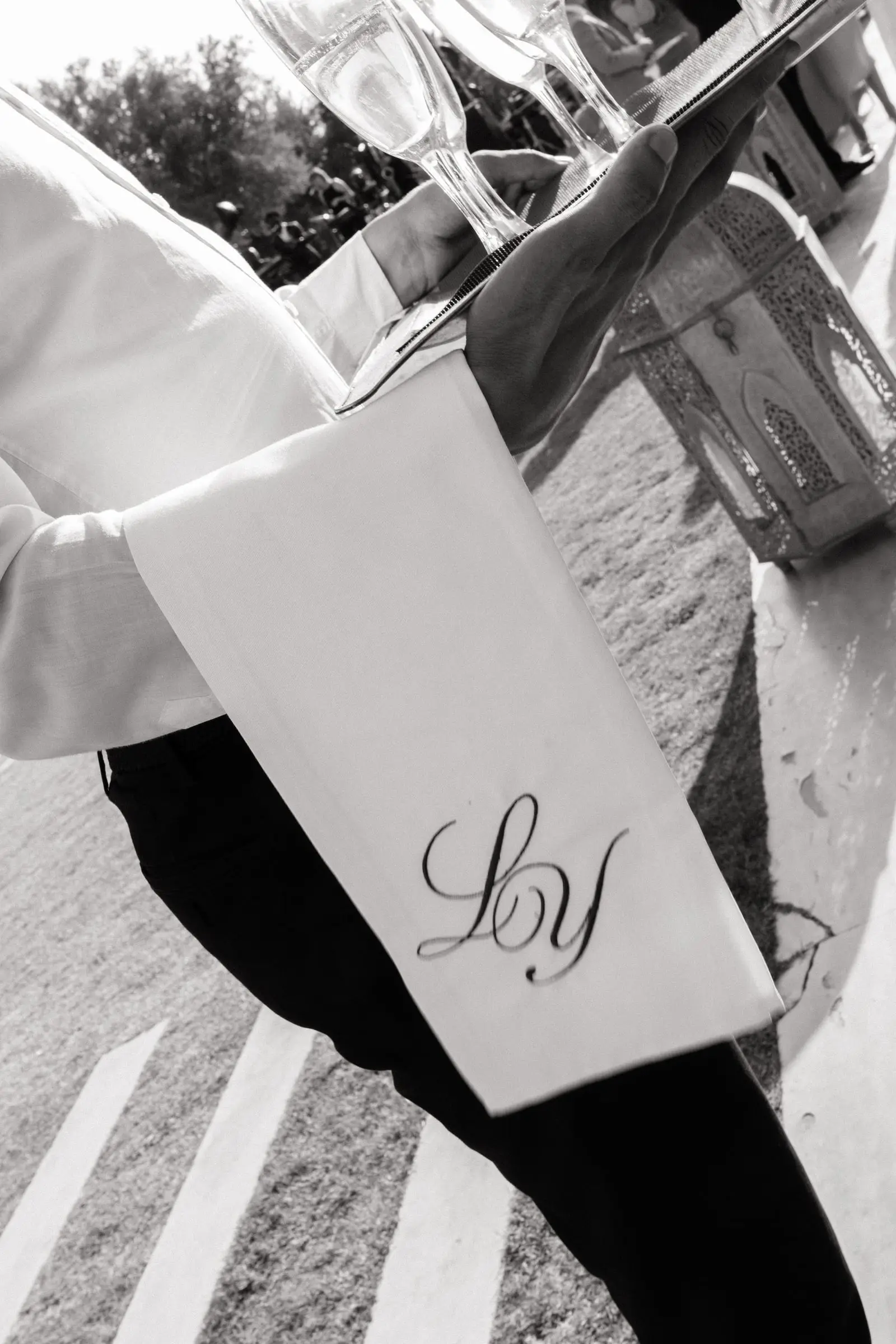 Black and white detail of a waiter's monogrammed napkin