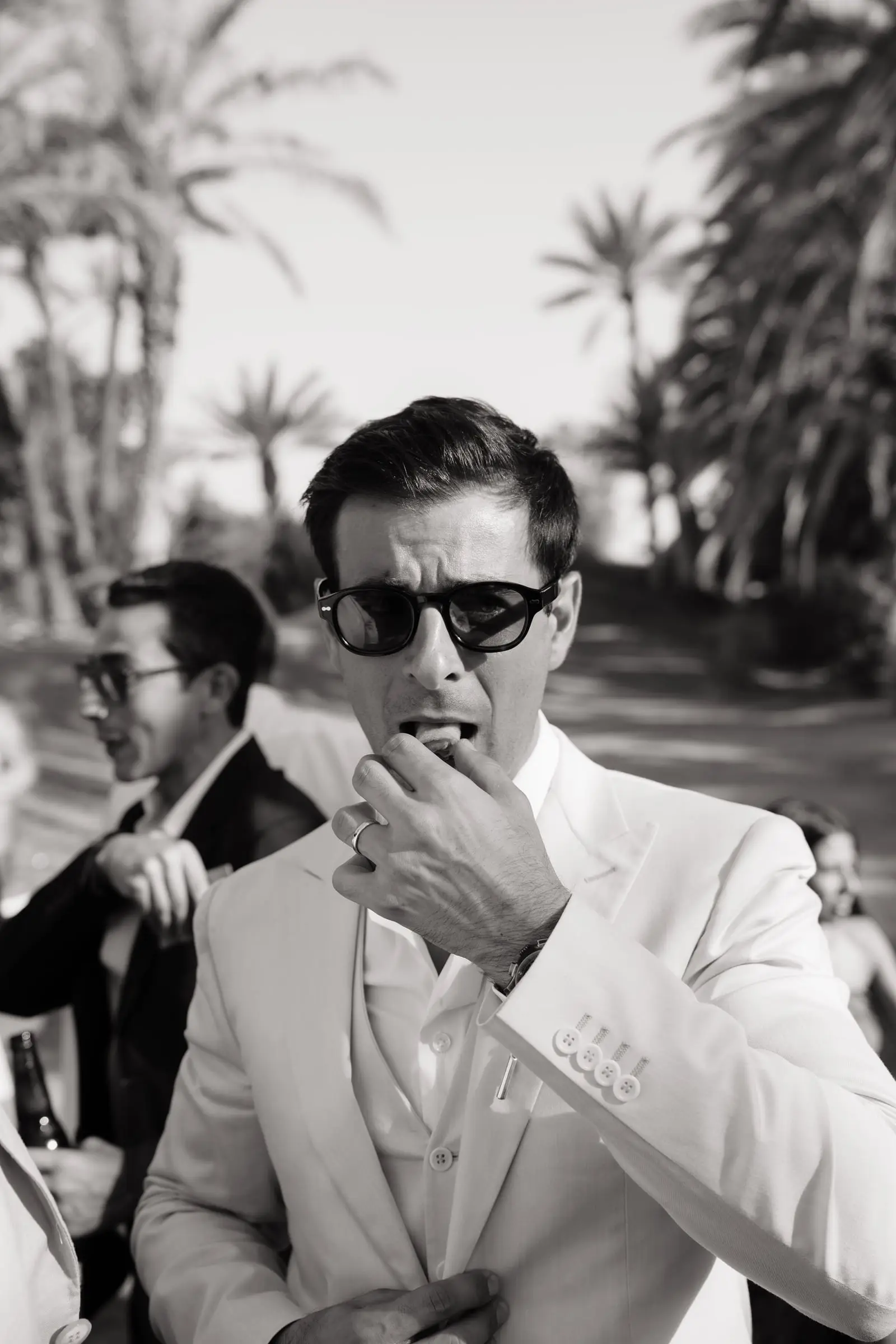 Black and white photo of a guest in sunglasses at the reception