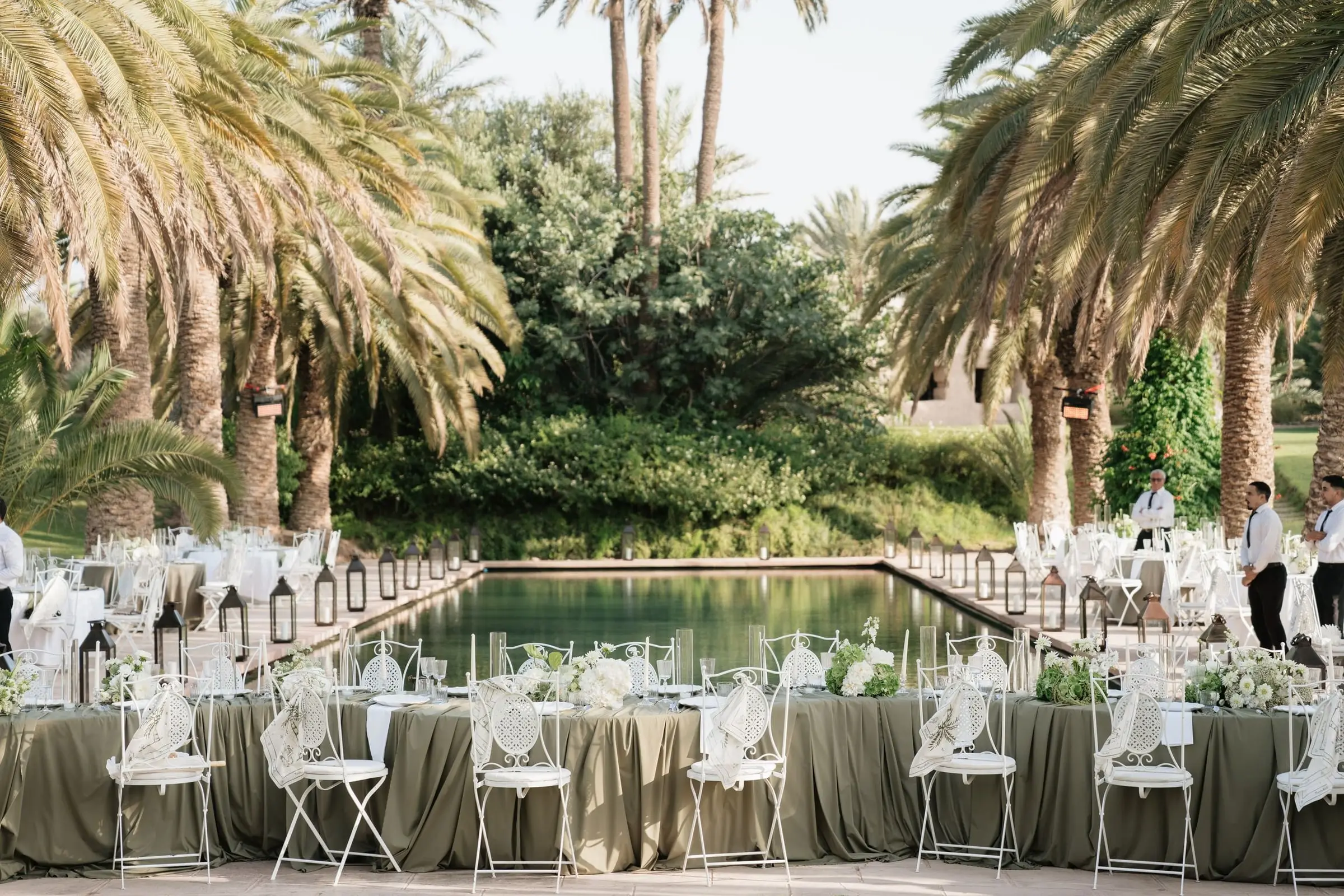 Dinner tables around the palm-lined pool of Ksar Char Bagh