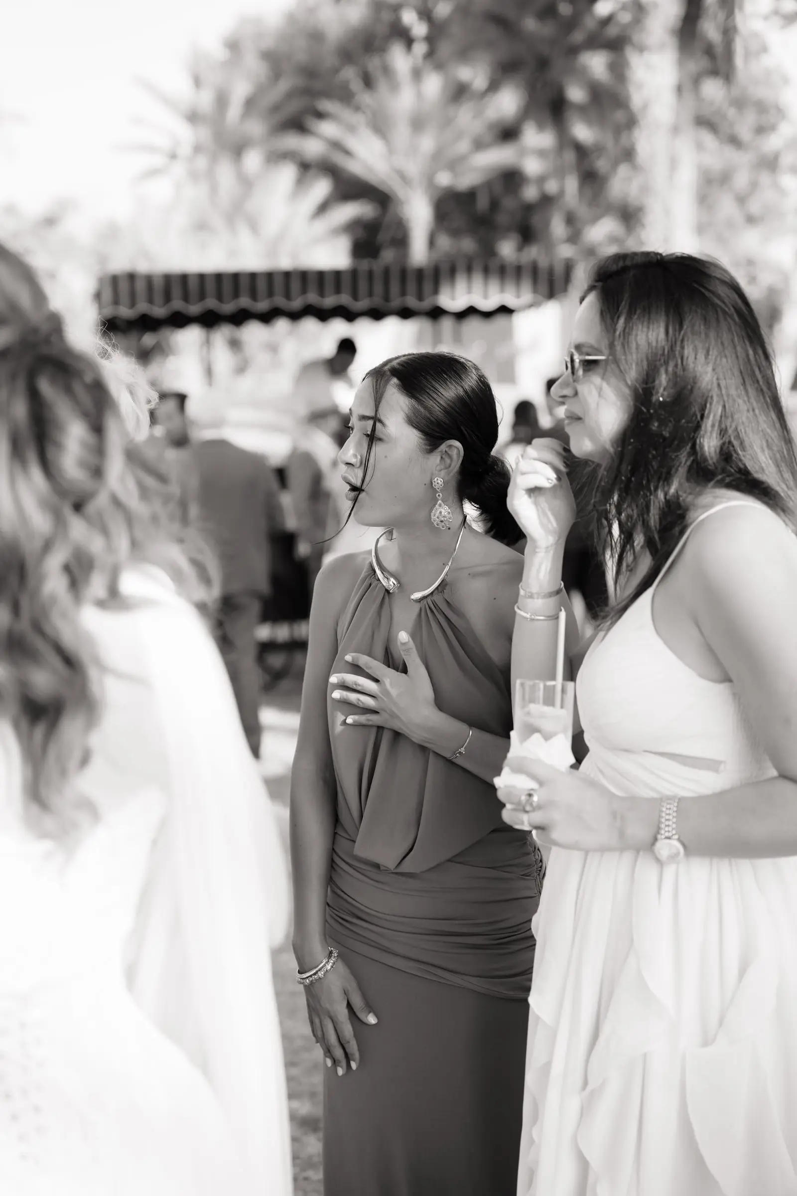 Black and white photo of guests chatting at the reception