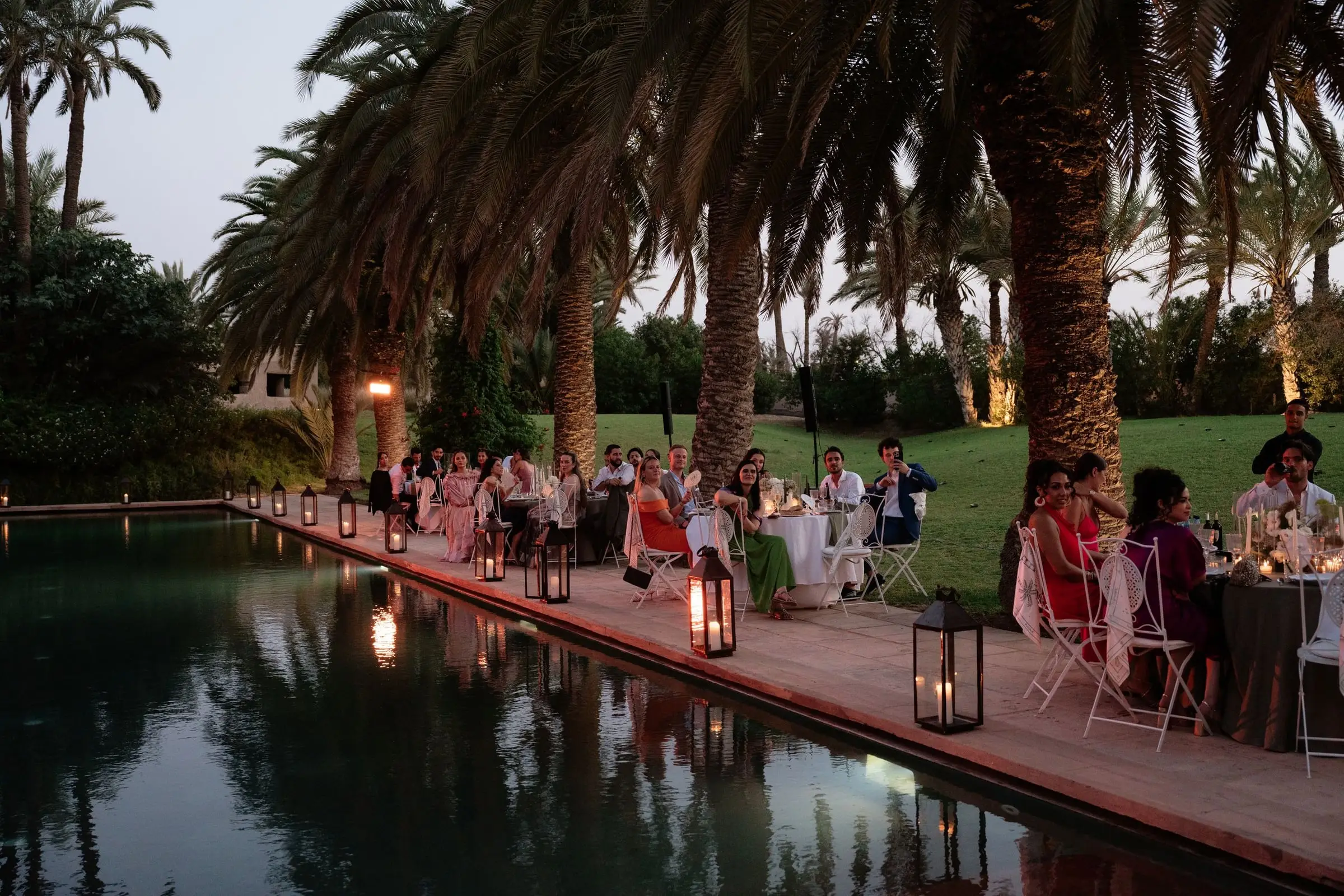 Candlelit dinner by the reflecting pool at dusk