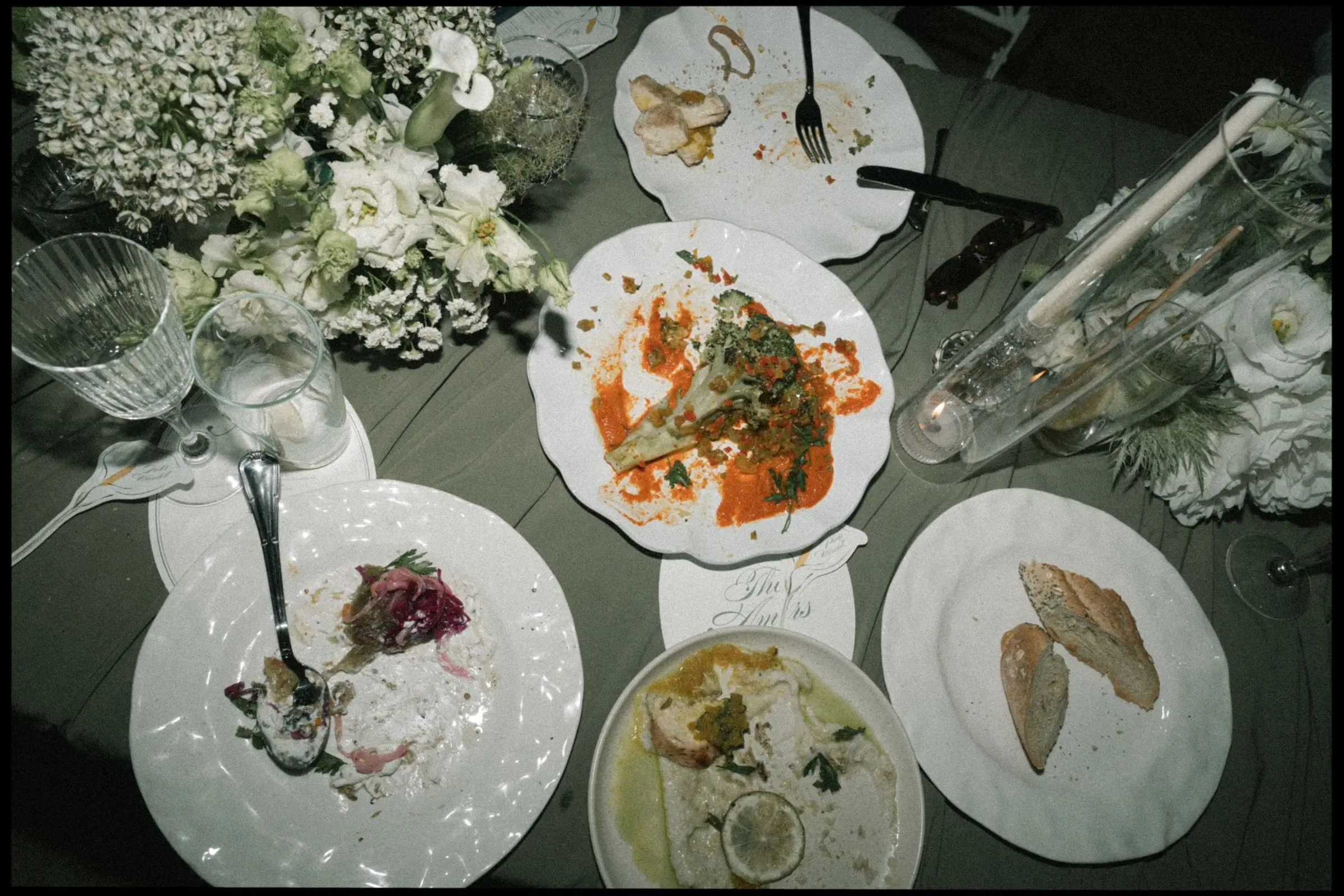 Dinner table seen from above with plates and flowers, on film