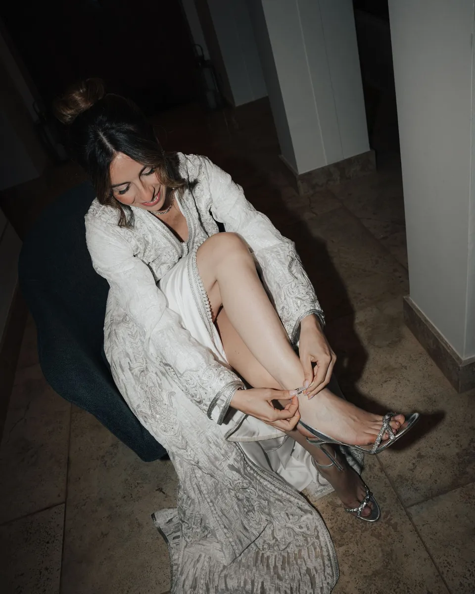 Bride changing her shoes during the party