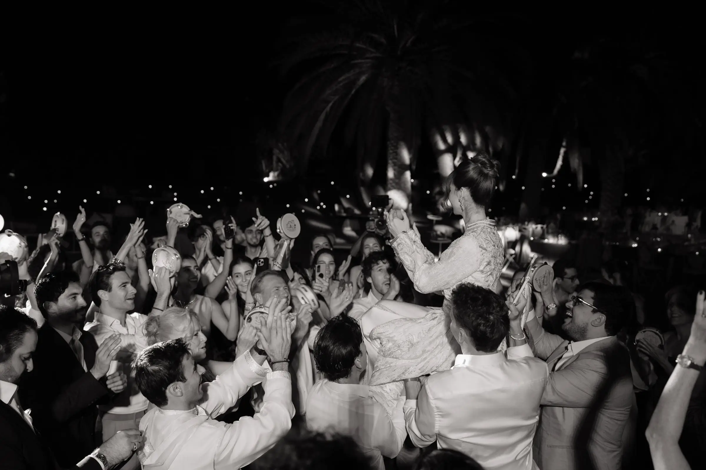 Black and white photo of the crowd dancing at night