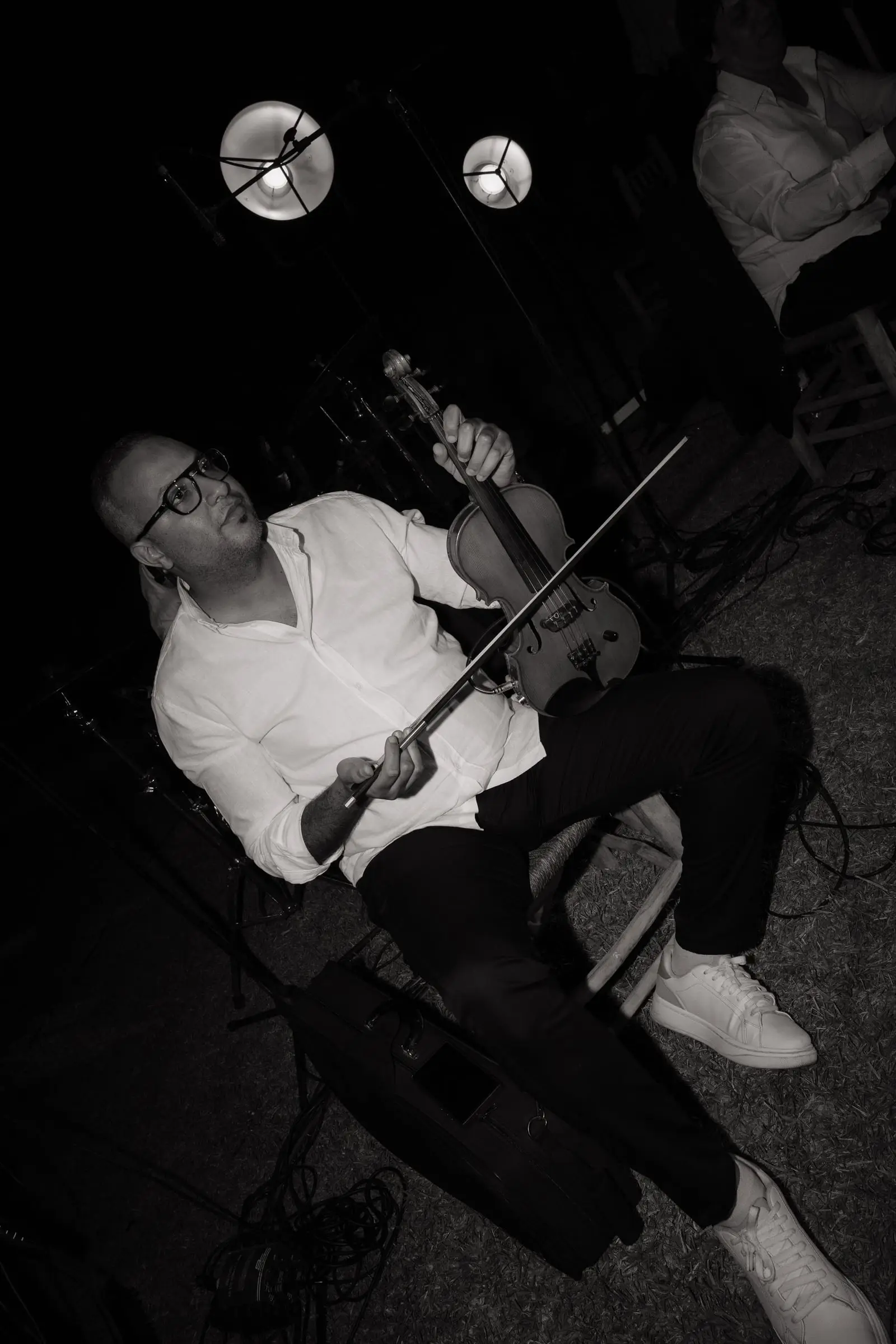 Black and white photo of a violinist playing at the party