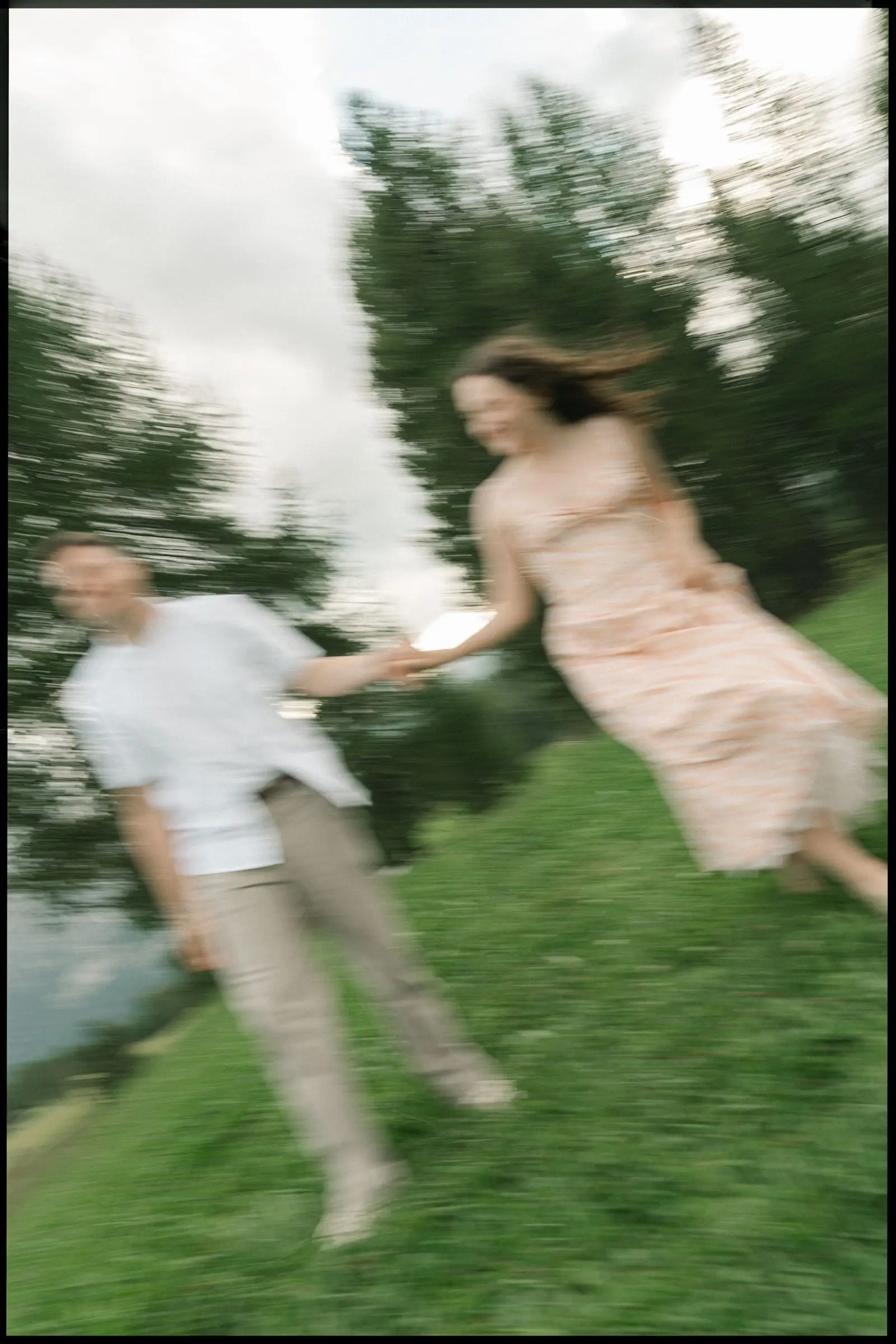 Motion blur photo of the couple running hand in hand