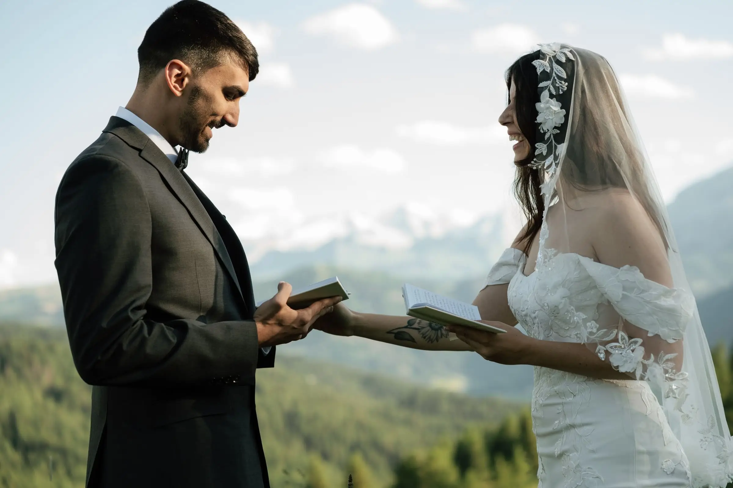Bride and groom reading their vows to each other in the mountains of La Val
