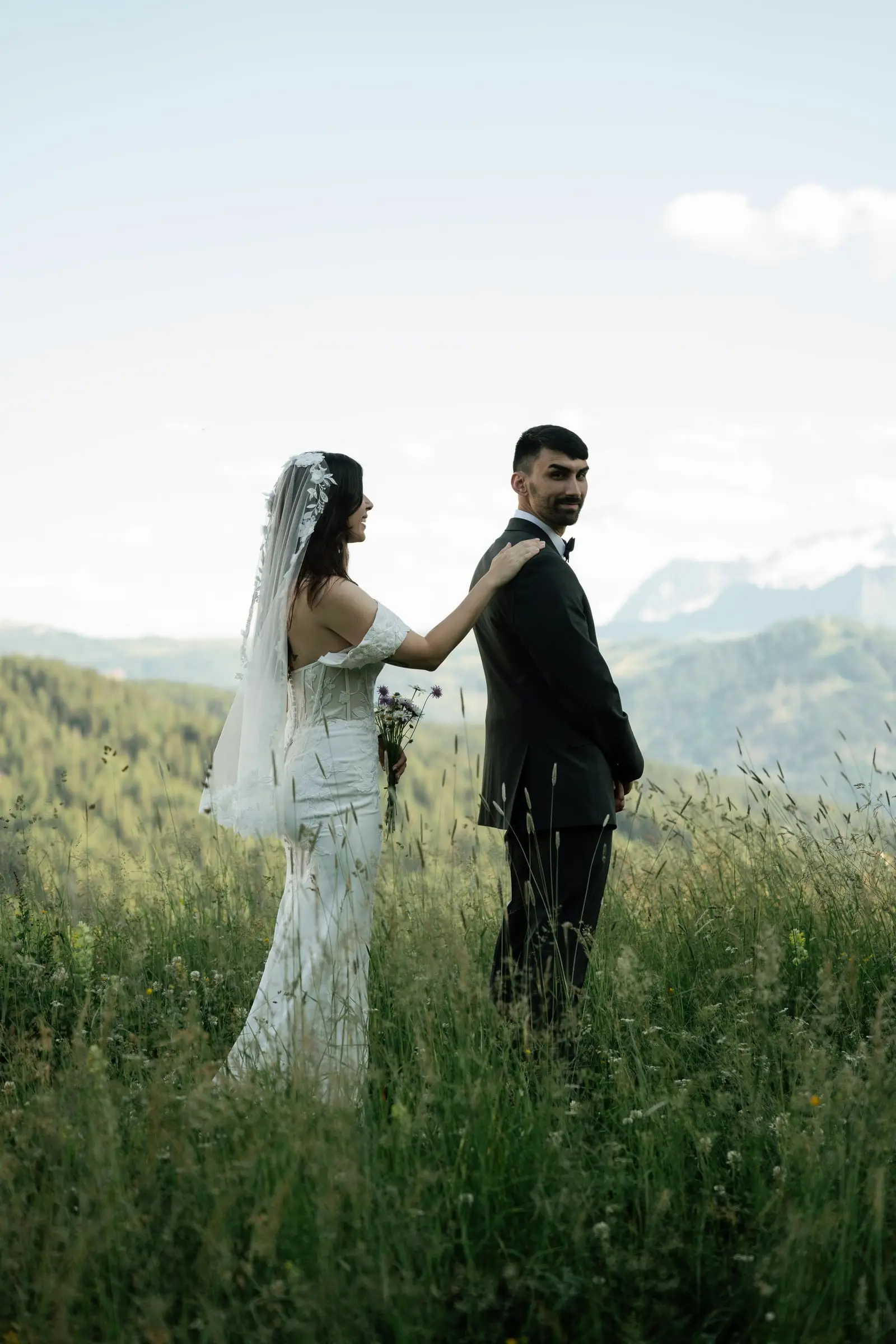Bride touches the groom's shoulder for the first look