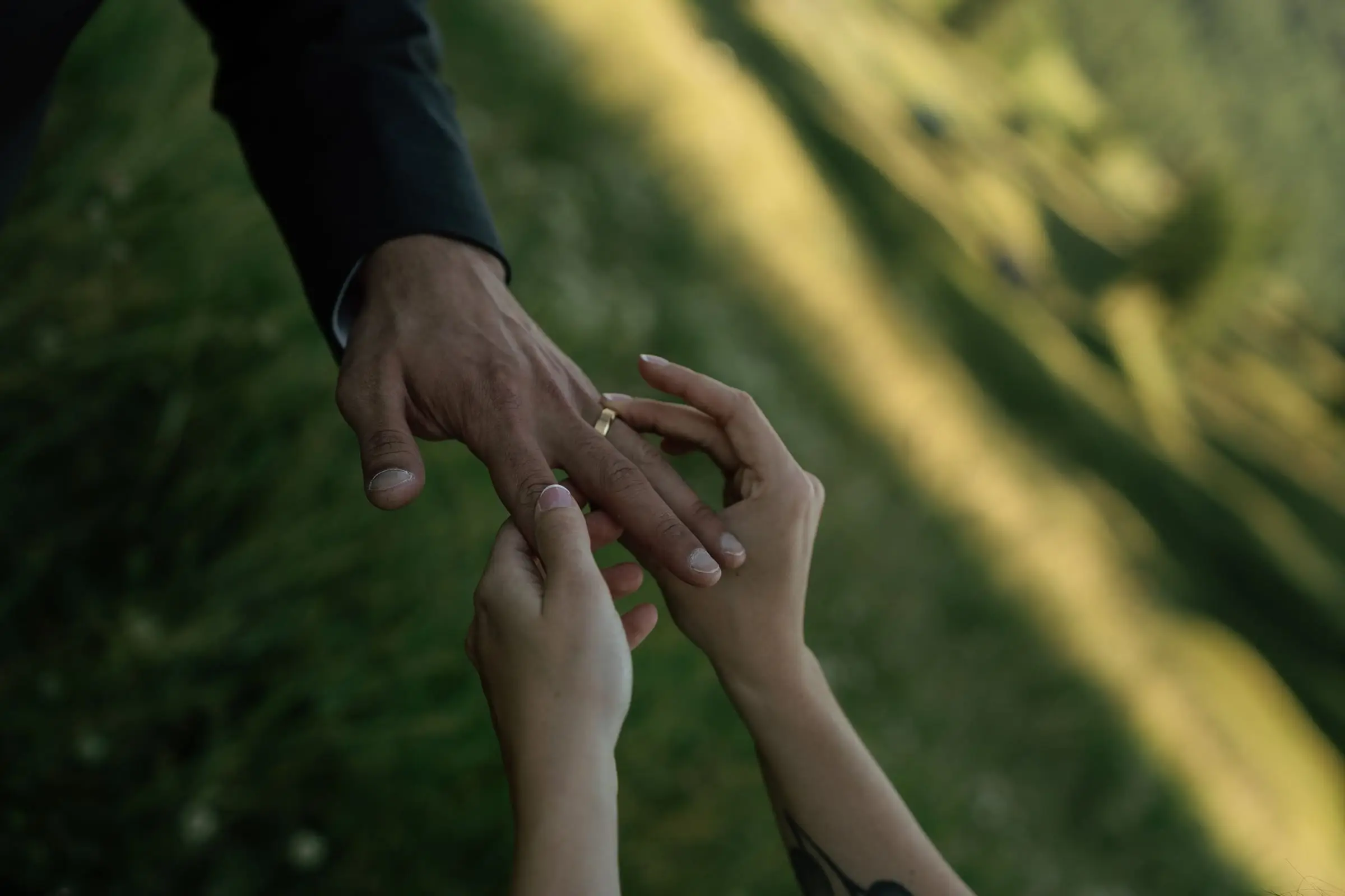 Bride puts the wedding ring on the groom's finger