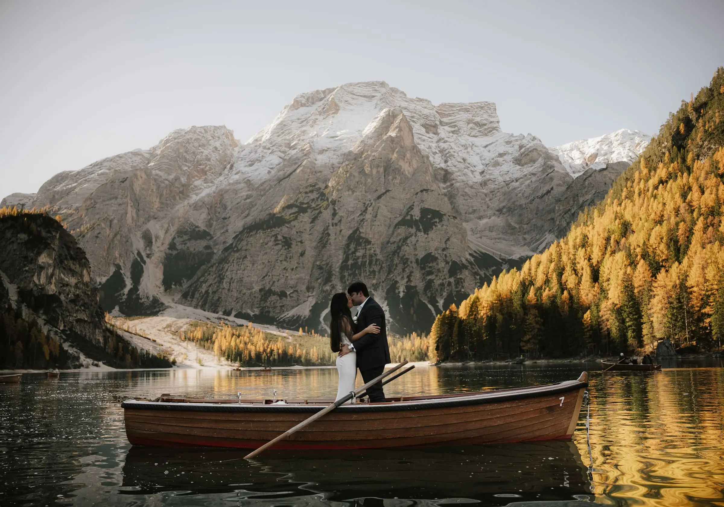 Couple embracing in a rowing boat on Lago di Braies below the Seekofel