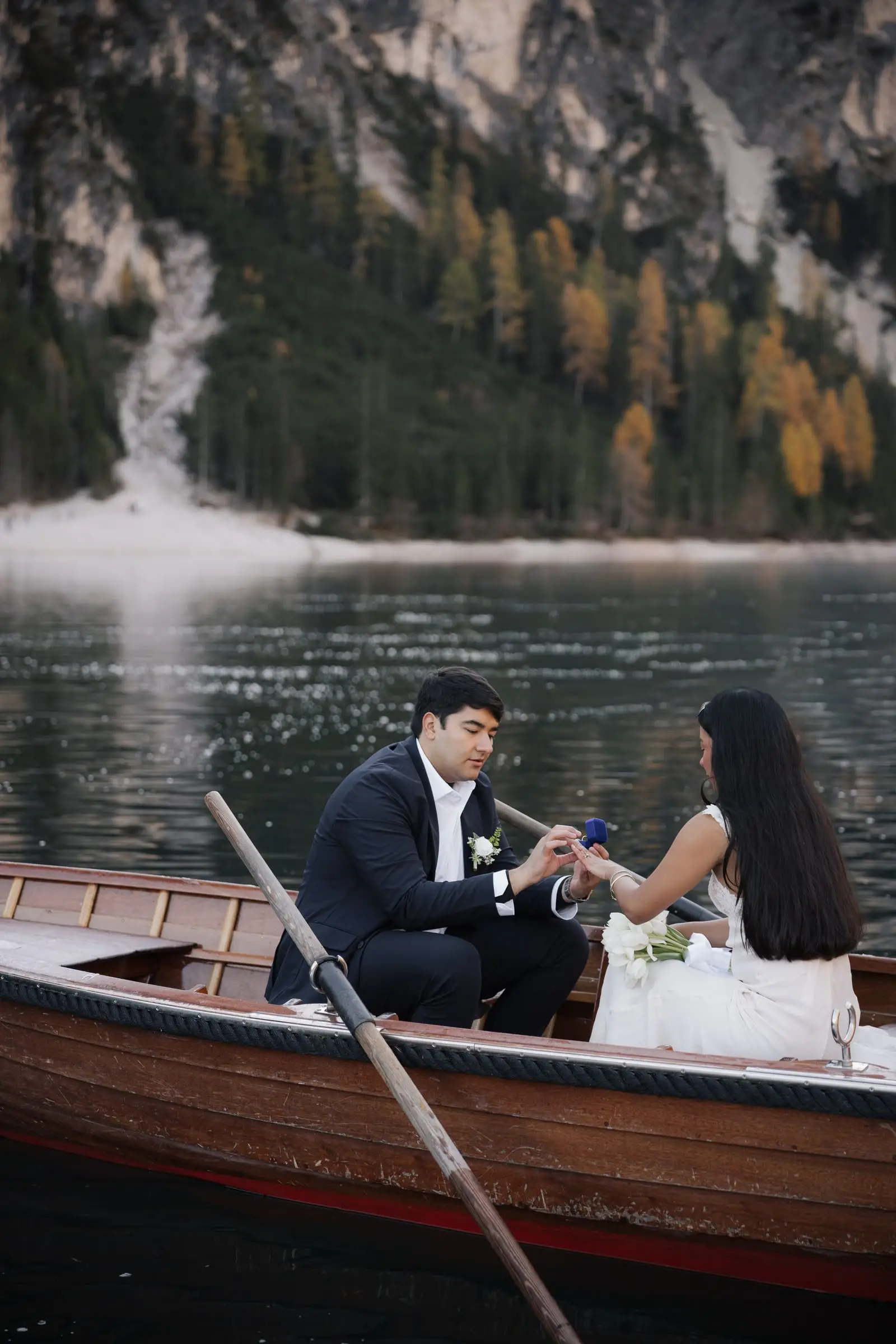 He gives her a ring in the rowing boat on the lake