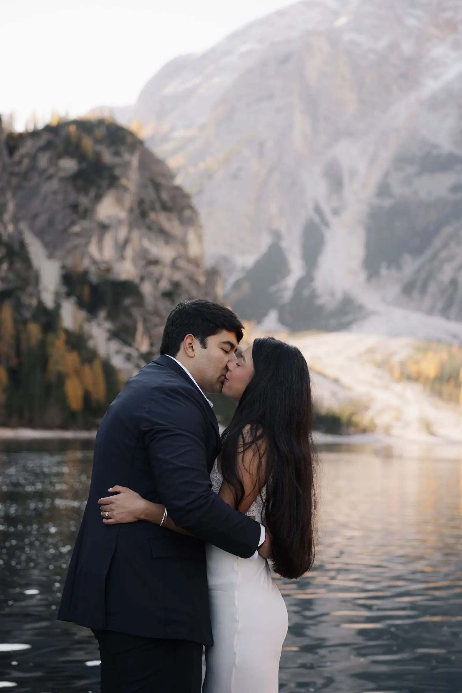 Couple kissing on the shore of the lake