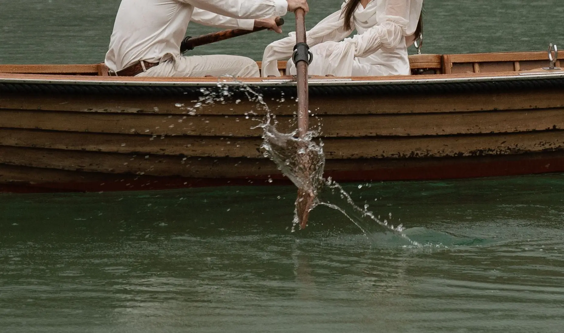 Oar splashing into the green water of Lago di Braies