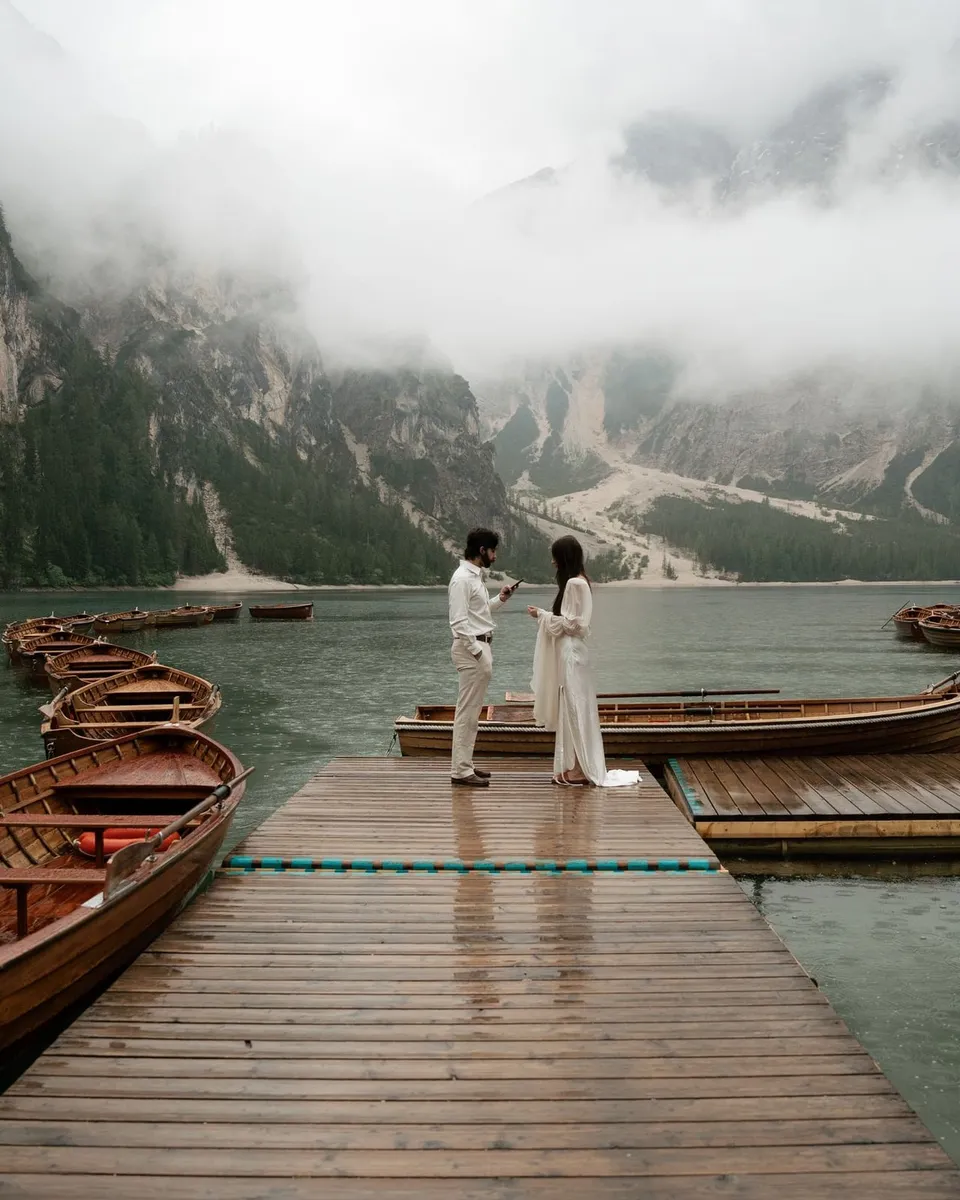 Couple exchanging vows on the jetty at Lago di Braies in the mist
