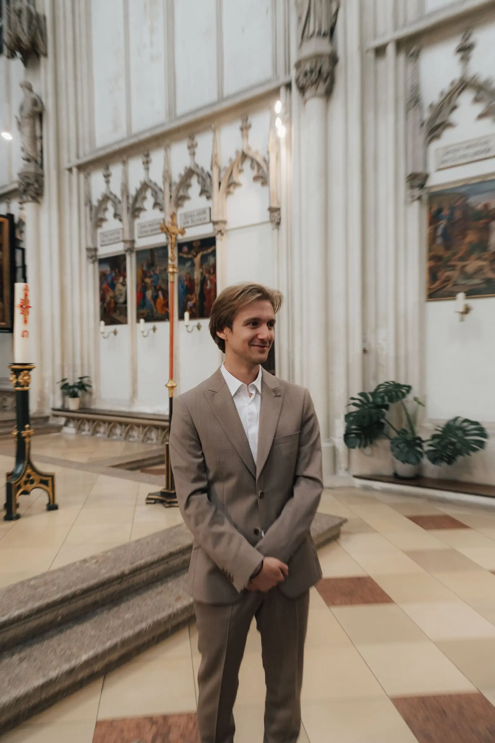 Groom smiling as he waits at the altar of Maria am Gestade