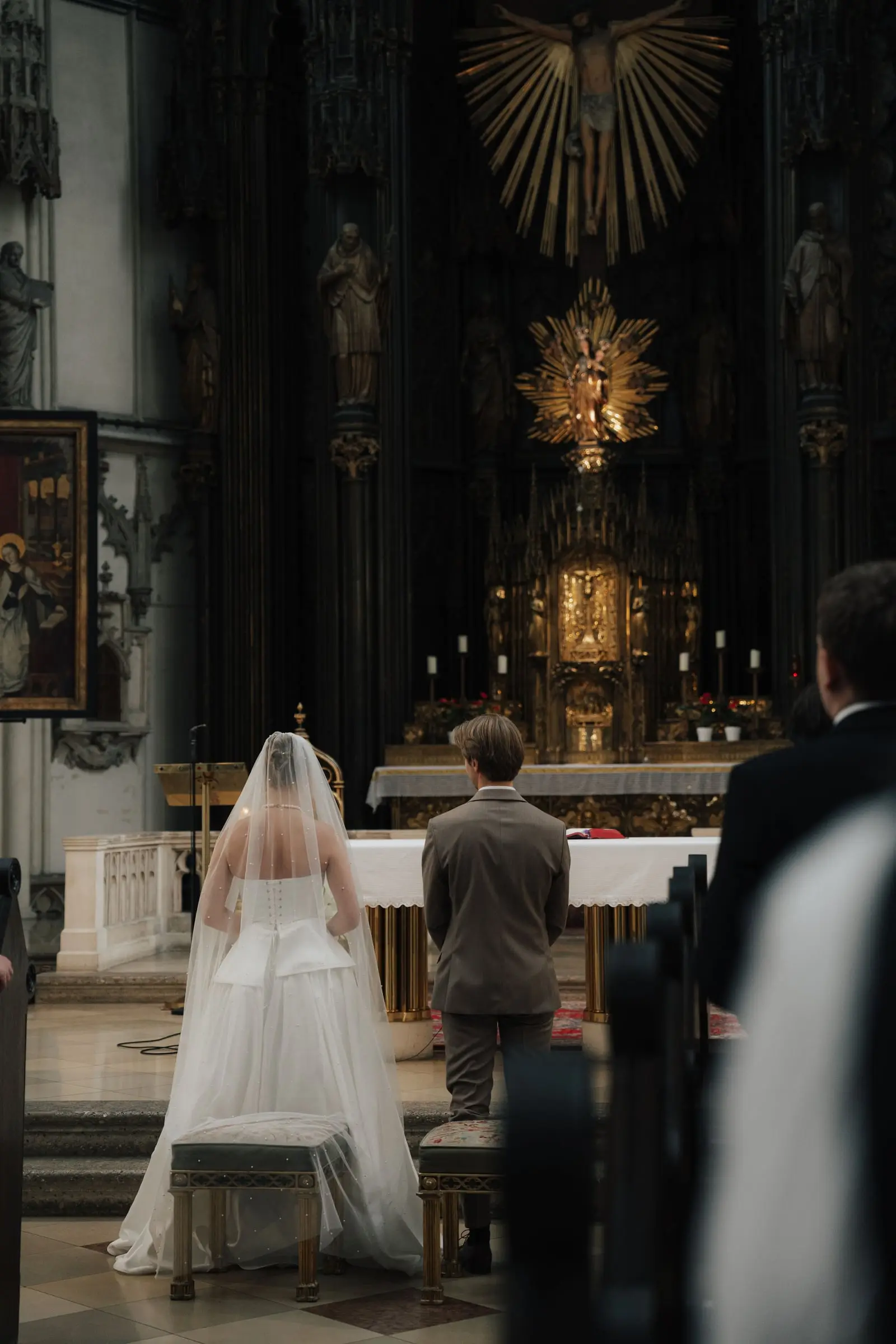 Bride and groom kneeling at the altar during the church ceremony