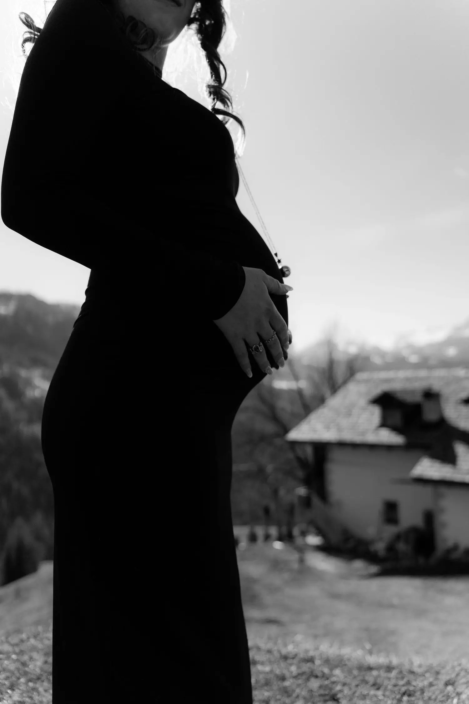 Black and white silhouette of the baby bump in a black dress