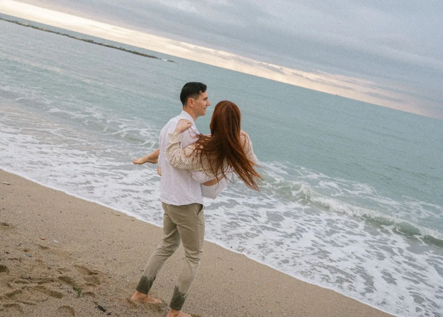 He spins the mother-to-be at the edge of the sea